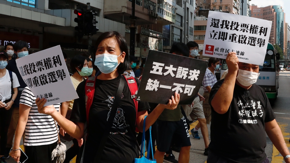 Pro-democracy protesters march during a demonstration oppose postponed elections, in Hong Kong