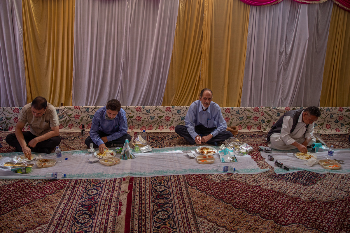 Kashmiri men eat a wedding feast Wazwan as they maintain social distance due to COVID-19 at a wedding on the outskirts of Srinagar, Indian controlled Kashmir, Tuesday, Sept. 15, 2020. The coronavirus