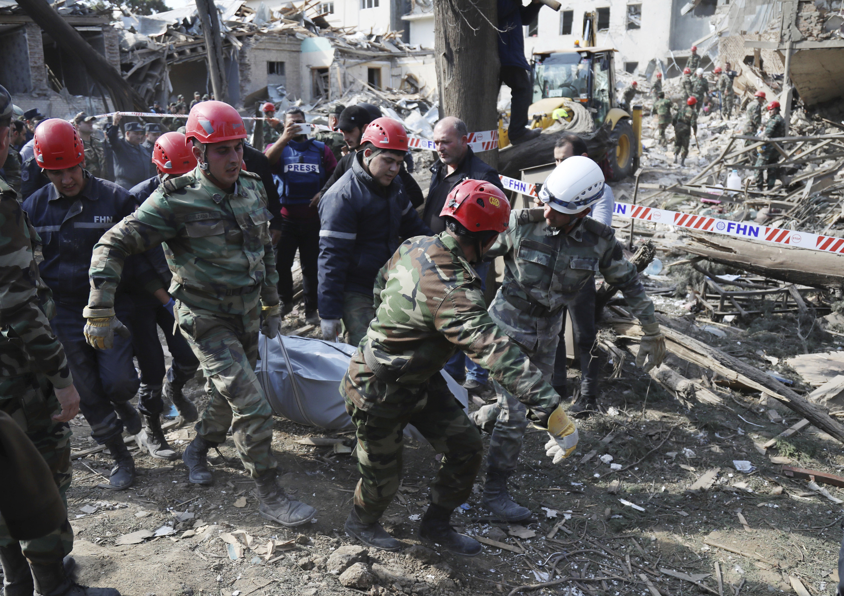 Rescuers carry an injured person to an ambulance after shelling by Armenian artillery during fighting in Ganja, Azerbaijan on October 11, 2020 [AP/Aziz Karimov]