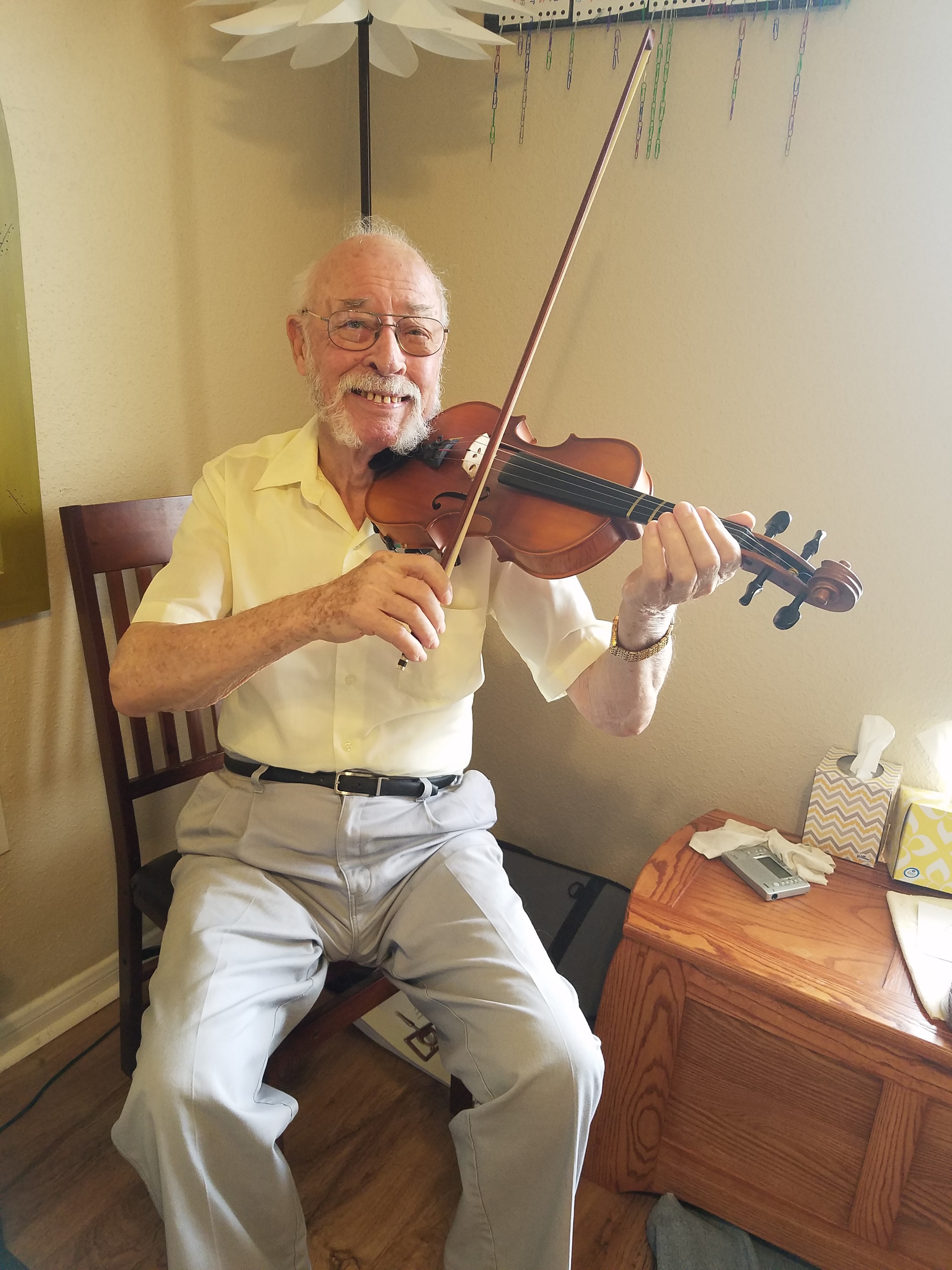 Richard poses with his violin during a lesson [Photo courtesy of Meghan Beaudry]
