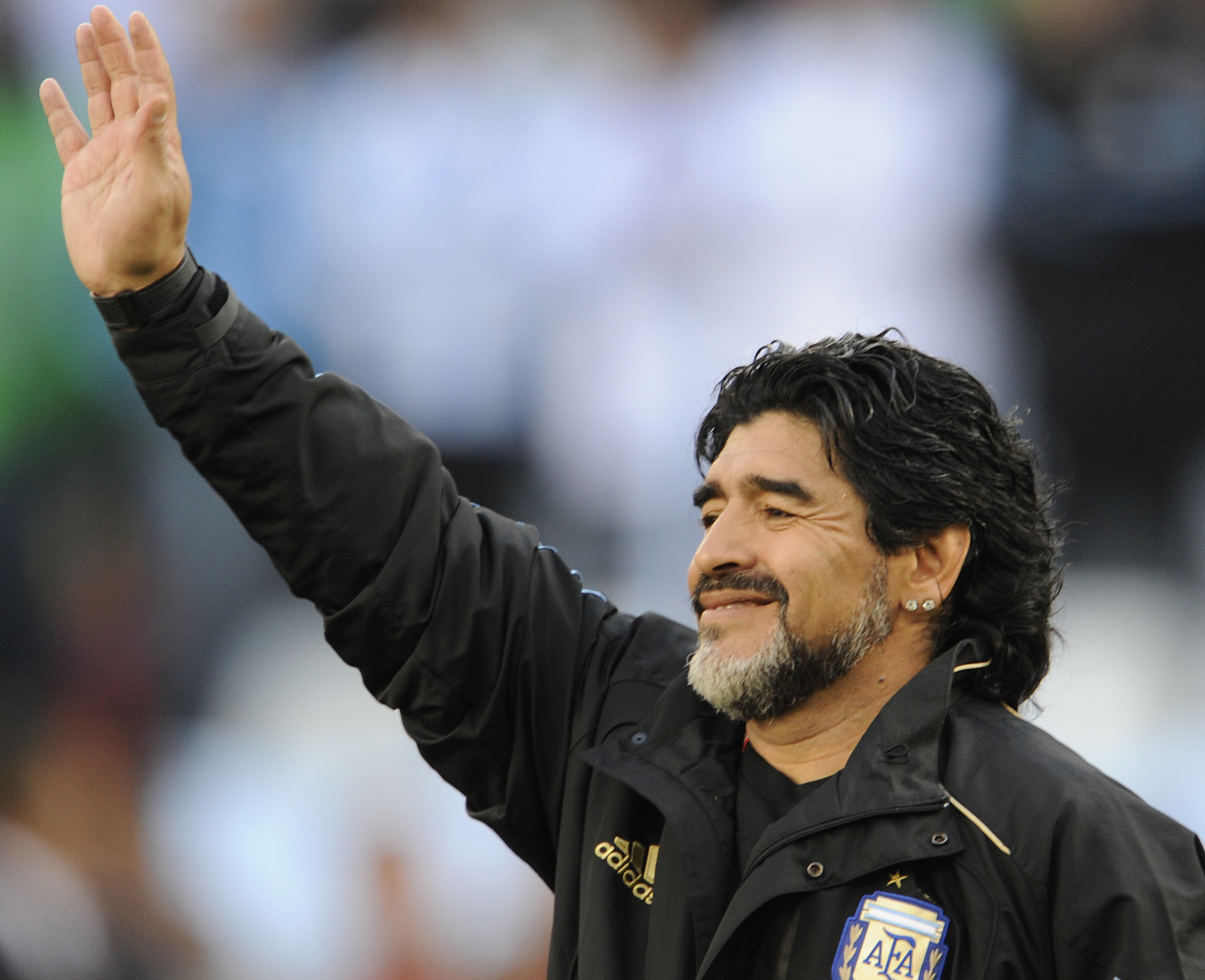 Diego Maradona waves to supporters.