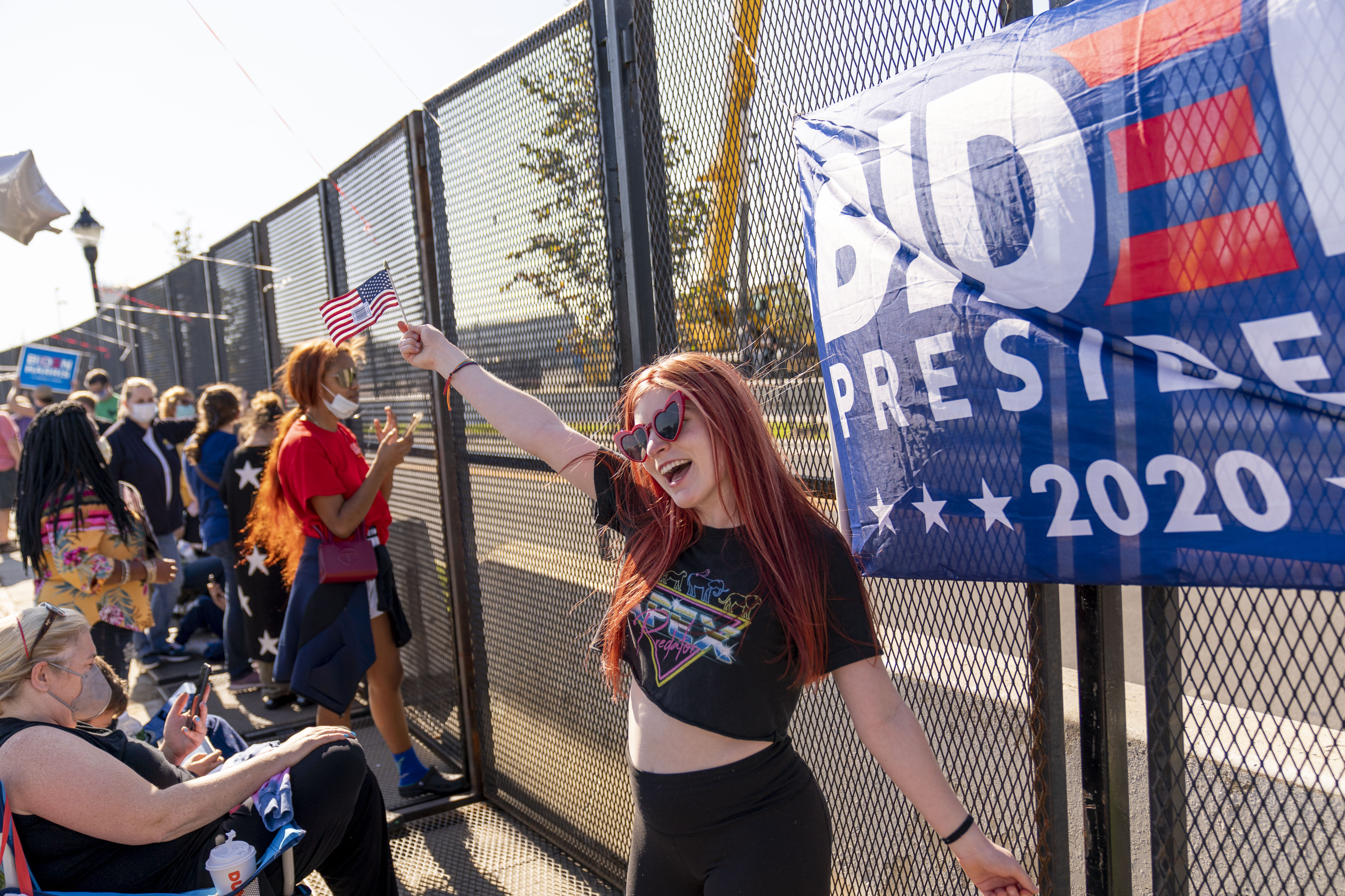 Supporters of President-elect Joe Biden congregate in a parking lot near Wilmington, Delaware’s Chase Center, where Biden’s victory rally is expected to happen tonight