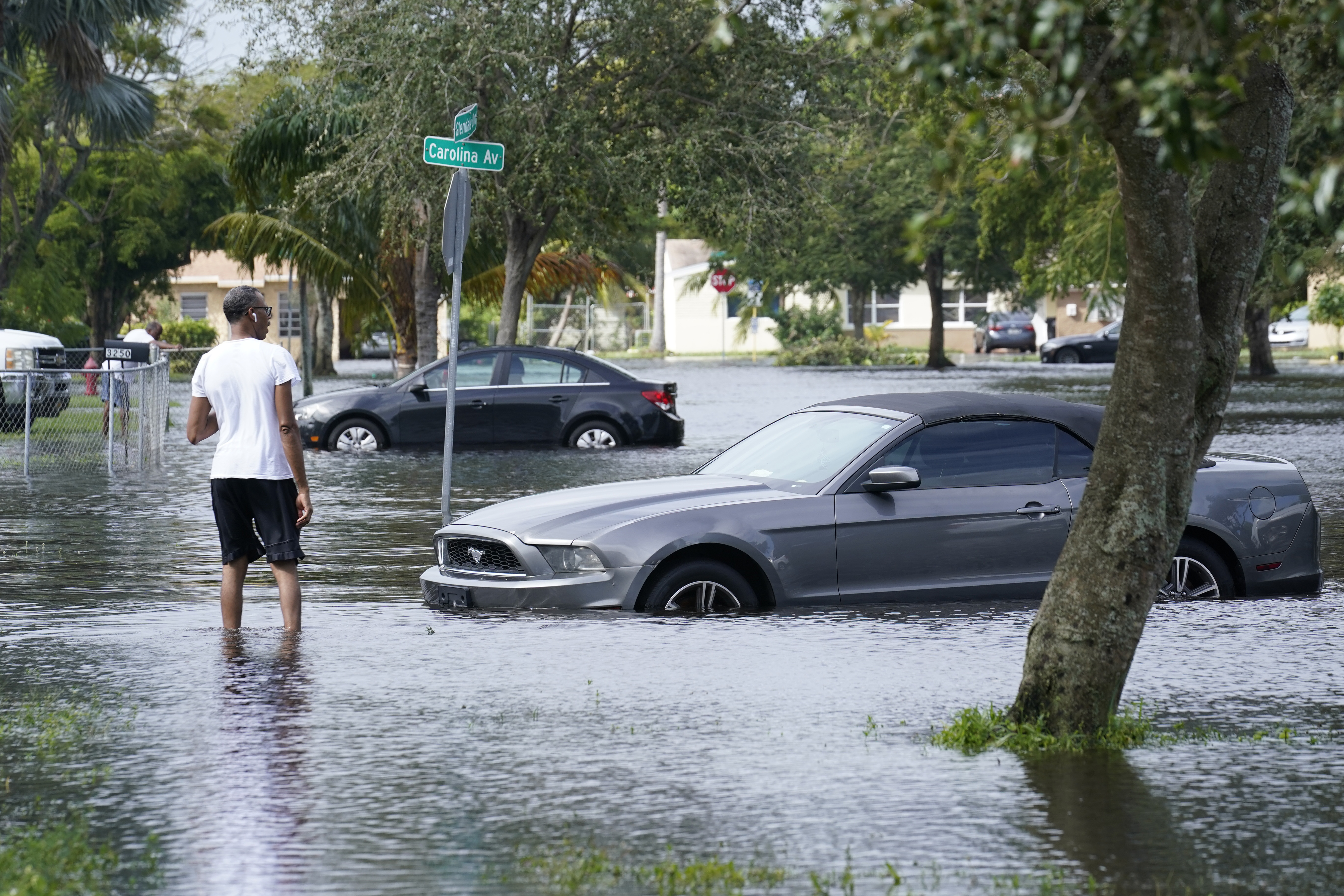 A man walking in a flooded street in Fort Lauderdale, Florida; Tropical Storm Eta caused severe flooding in South Florida in areas already saturated from previous downpours