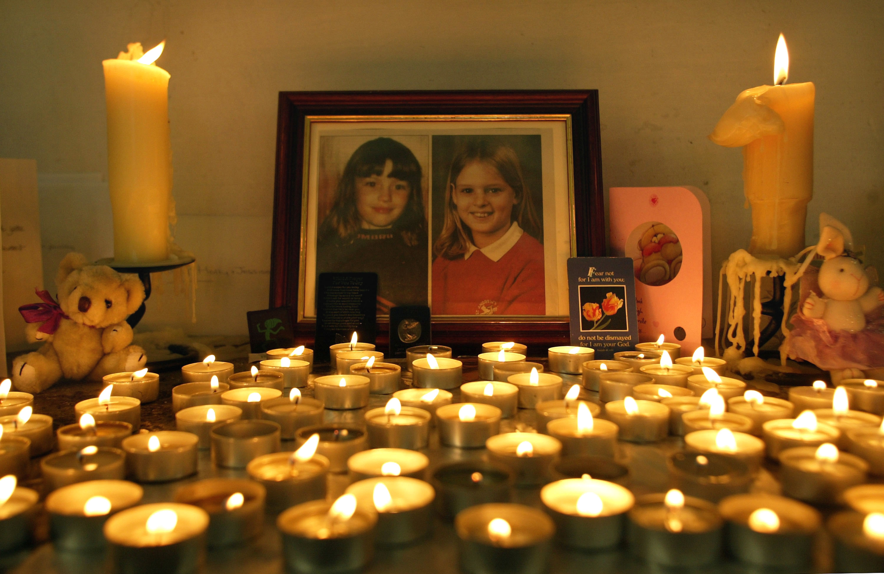 Candles are lit in remembrance of Holly Wells and Jessica Chapman inside St Andrew’s Church on August 18, 2002 in Soham, Cambridgeshire, England