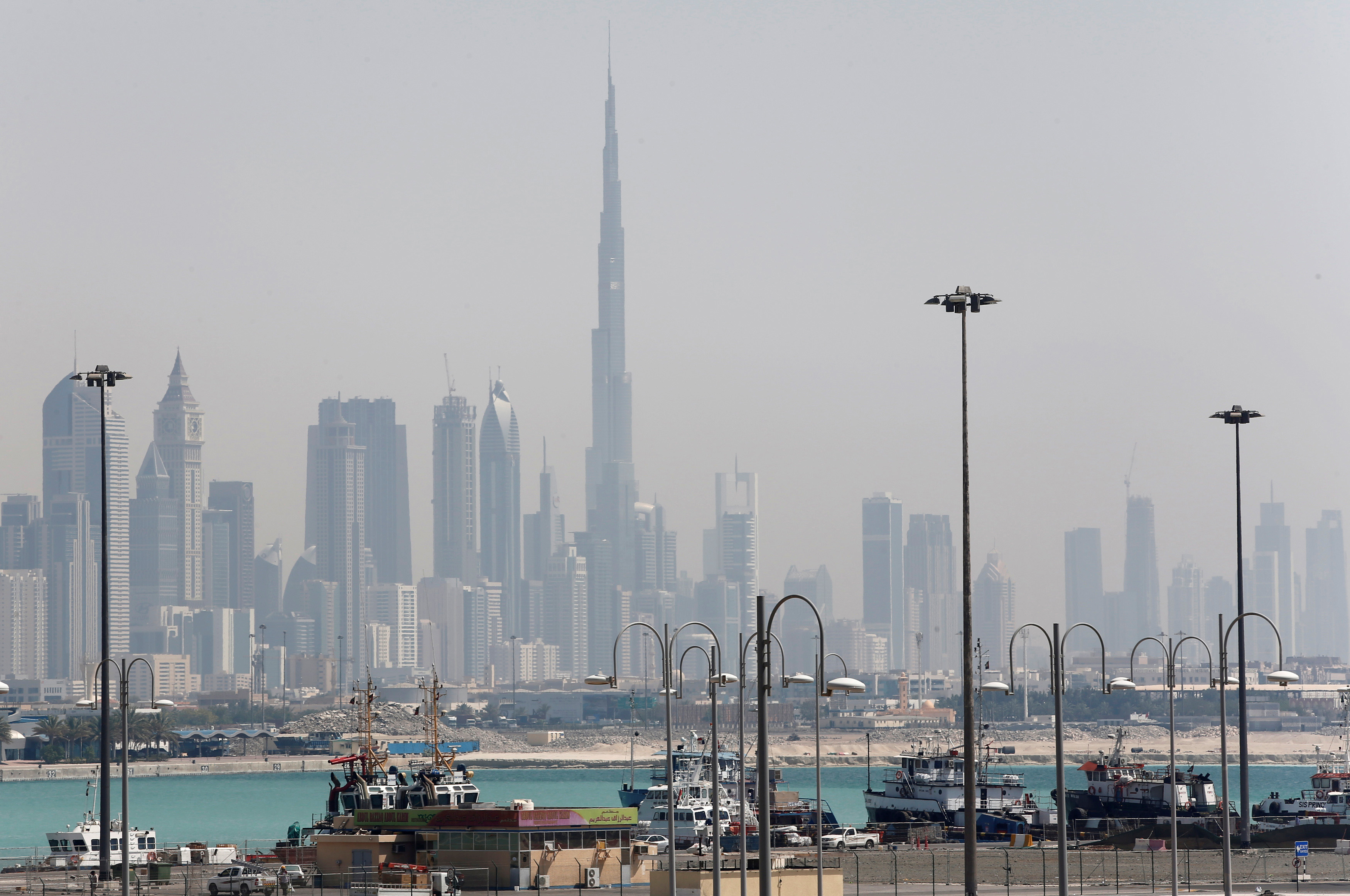 The skyline including the Burj Khalifa tower is seen as ships dock at Port Rashid in Dubai, the United Arab Emirates