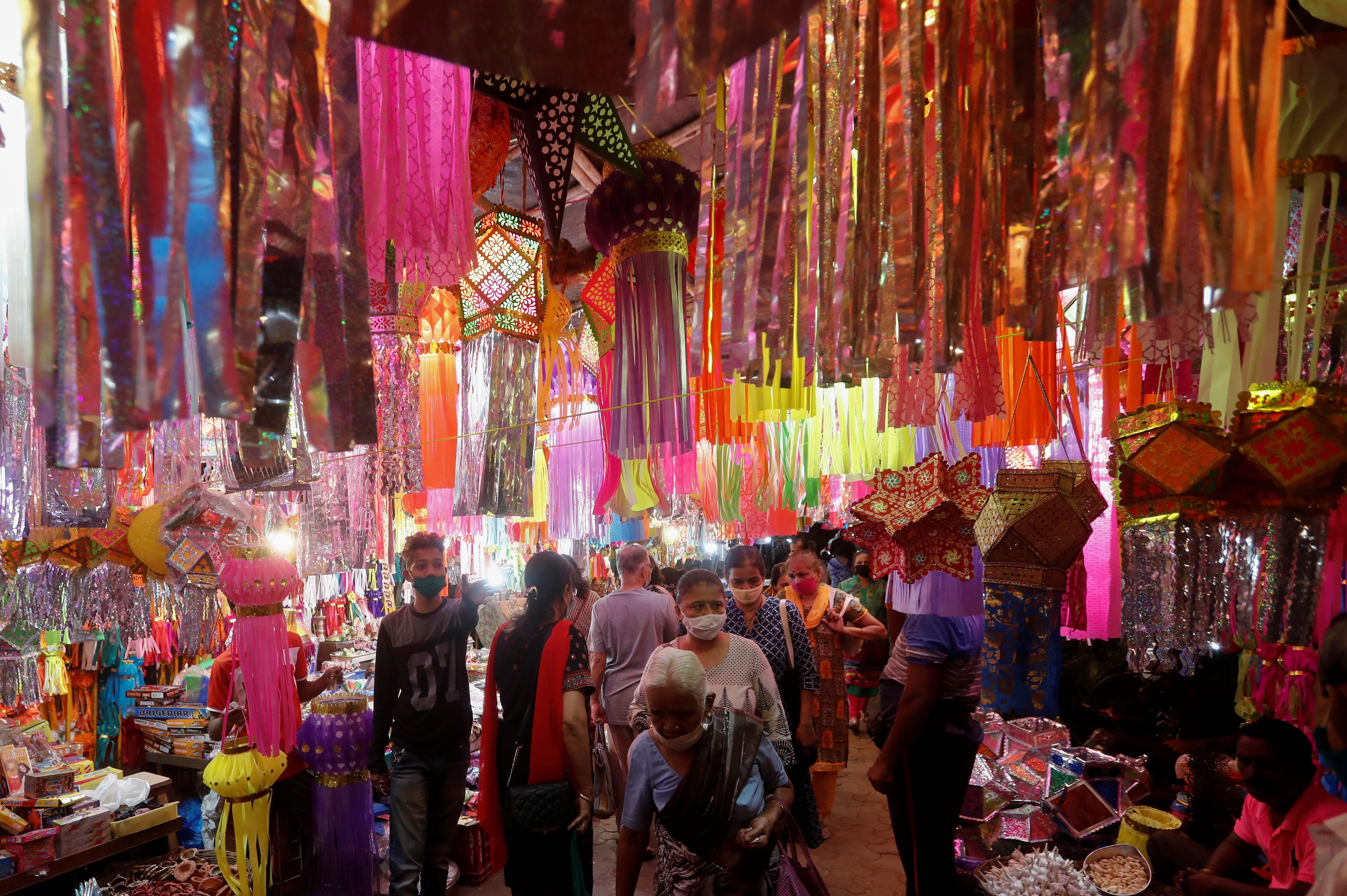 People shop for lanterns at a market before Diwali, the Hindu festival of lights, amid the spread of the coronavirus in Mumbai, India