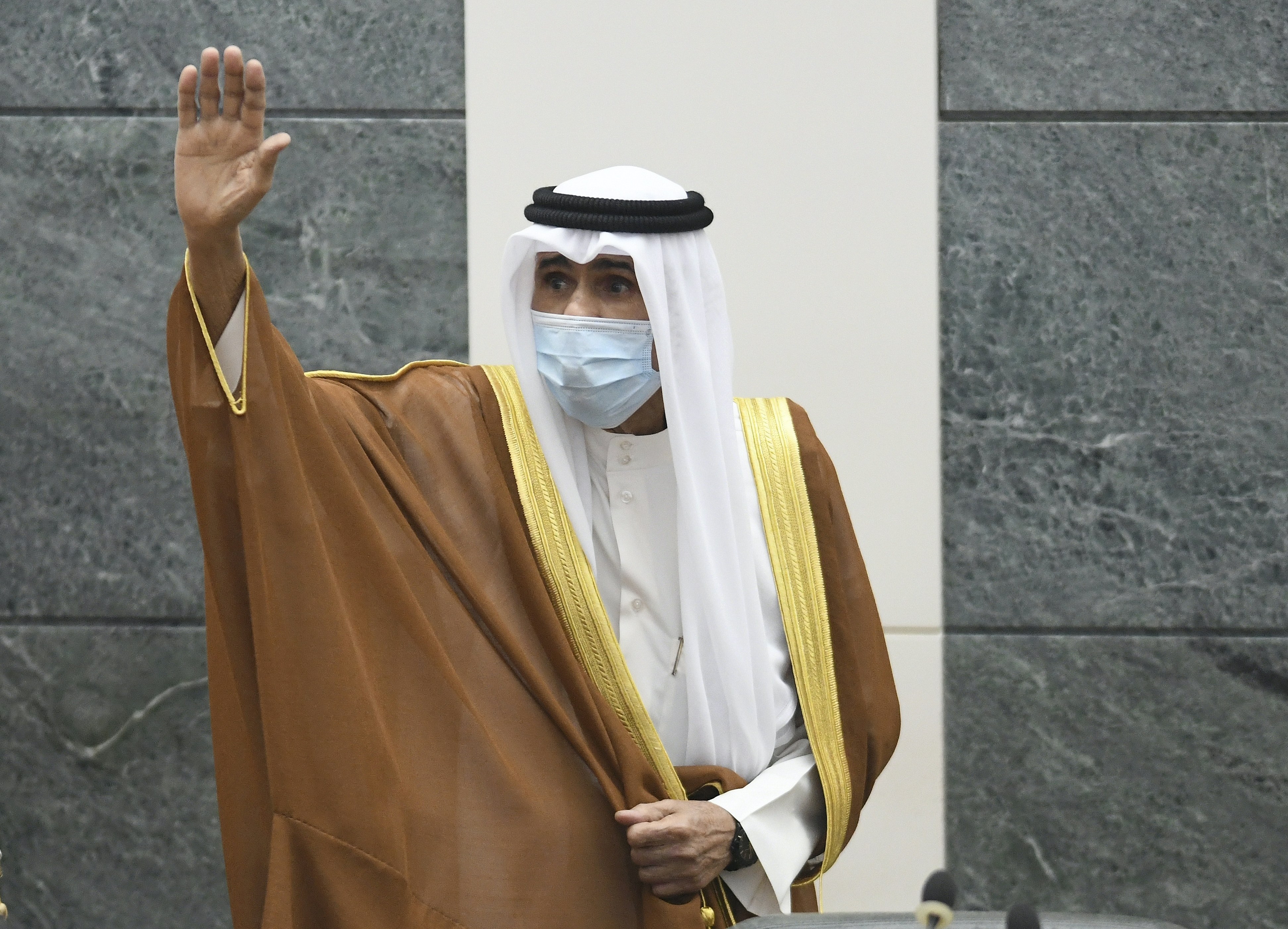 Kuwait’s new Emir Sheikh Nawaf Al Ahmad Al Sabah waves after he performed the constitutional oath at the Kuwaiti National Assembly in Kuwait
