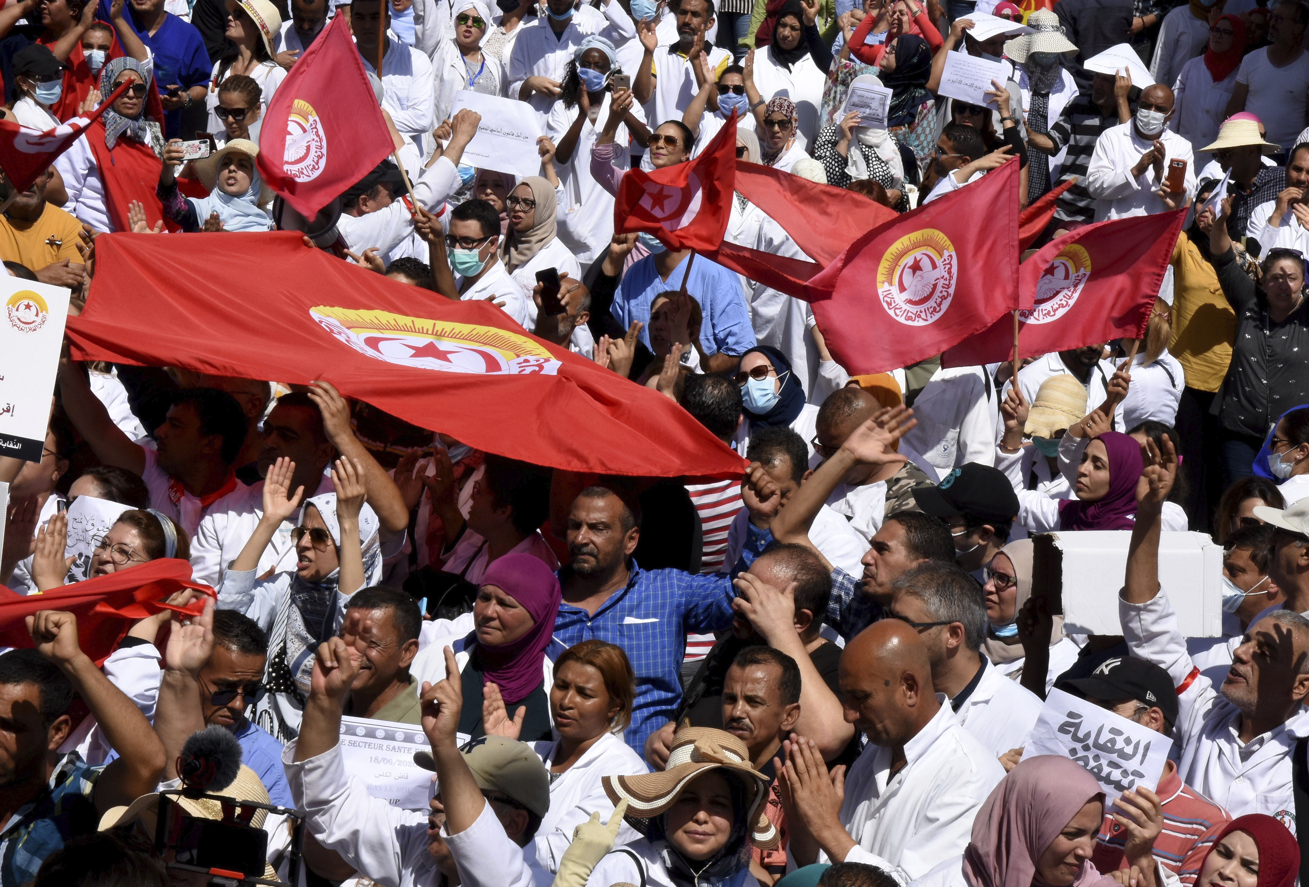 Tunisian health workers protest during a general strike organised by labour unions demanding pay raises and more government support in Tunis on June 18, 2020, as unemployment and poverty rise