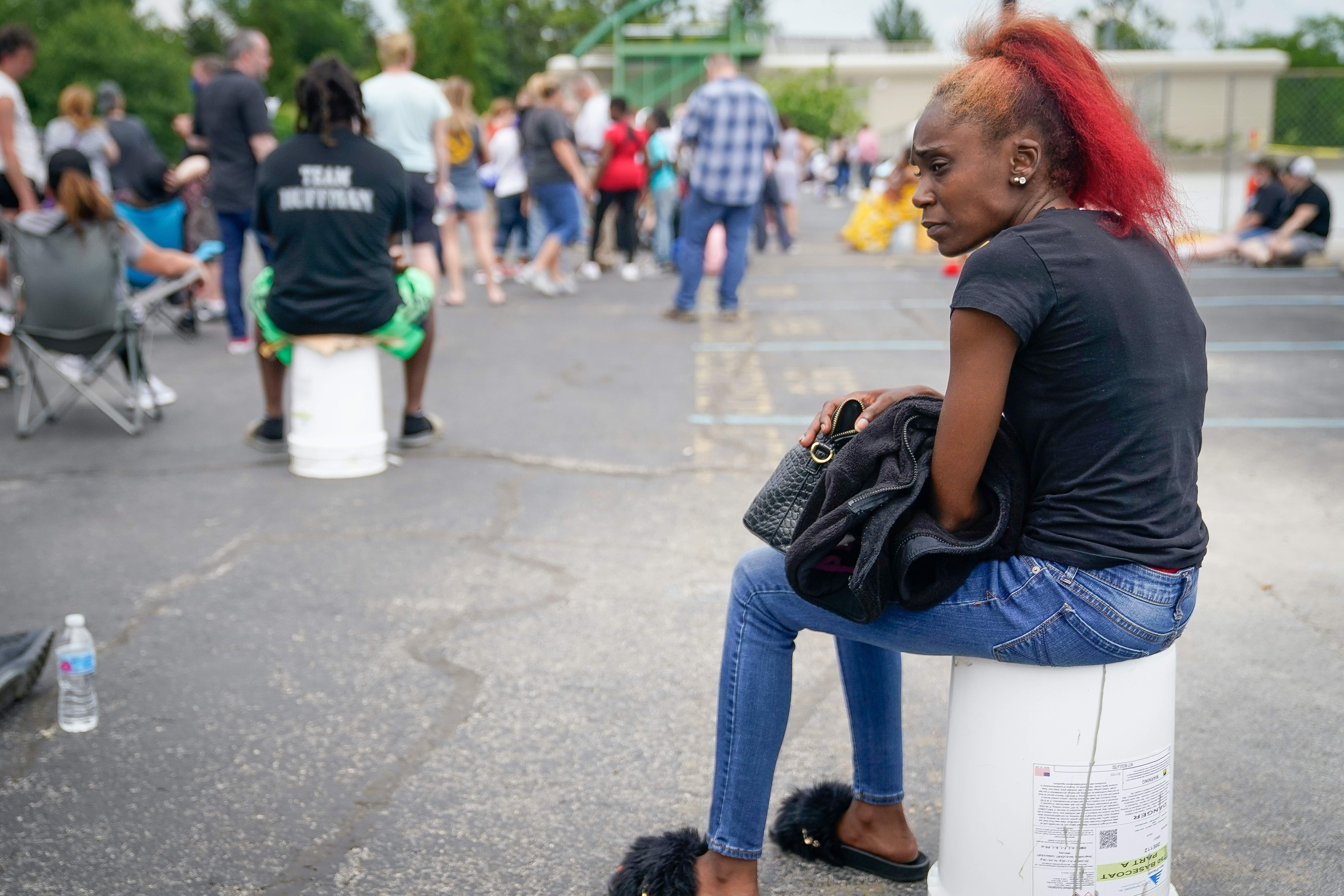A woman waits in line at the temporary unemployment office in Frankfort, Kentucky, the United States