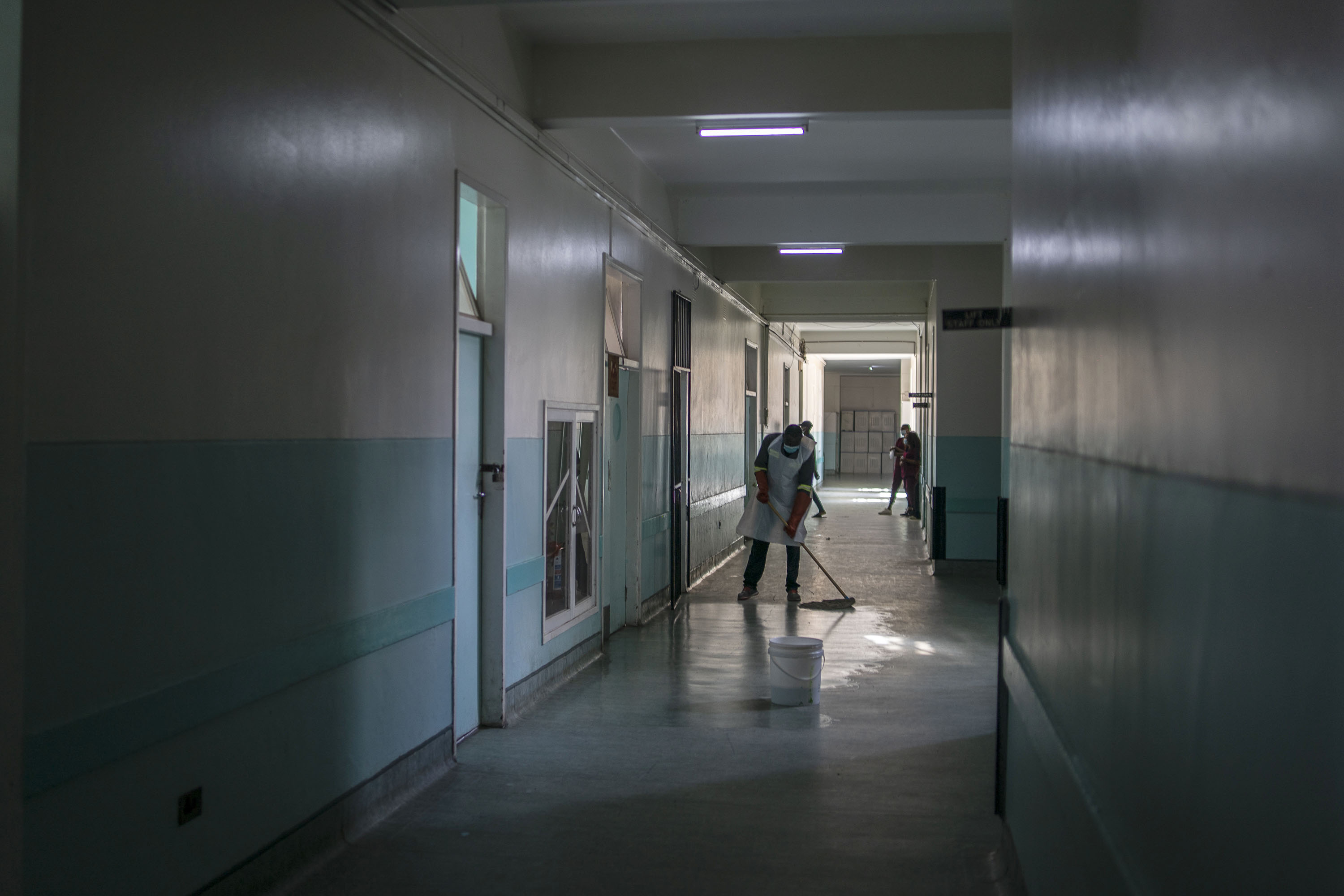 A member of staff cleans a corridor at Mpilo Central Hospital on January 28, 2021 in Bulawayo, Zimbabwe