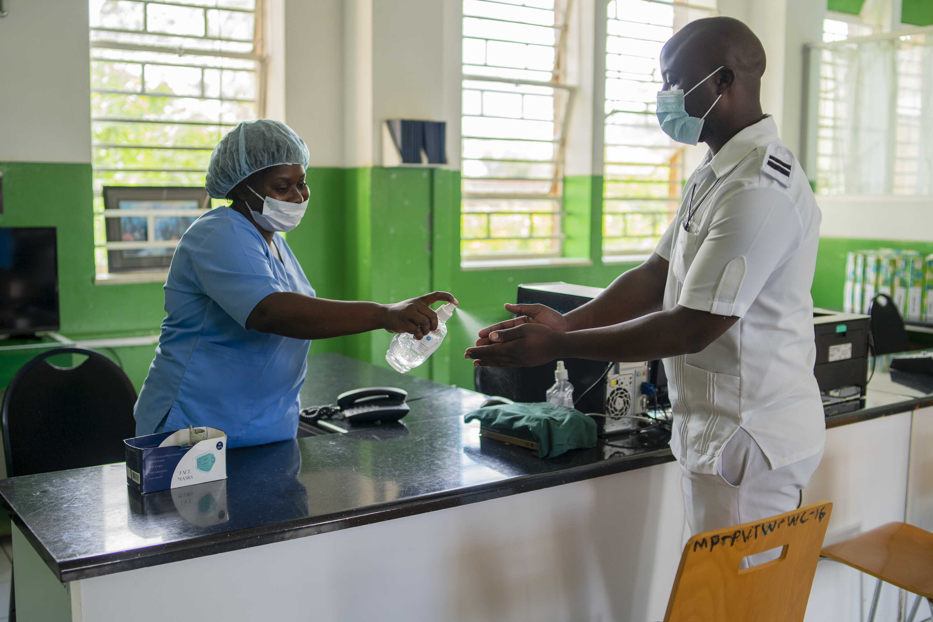 A health worker offers his hands for sanitising inside a ward at Mpilo Central Hospital on January 28, 2021 in Bulawayo, Zimbabwe