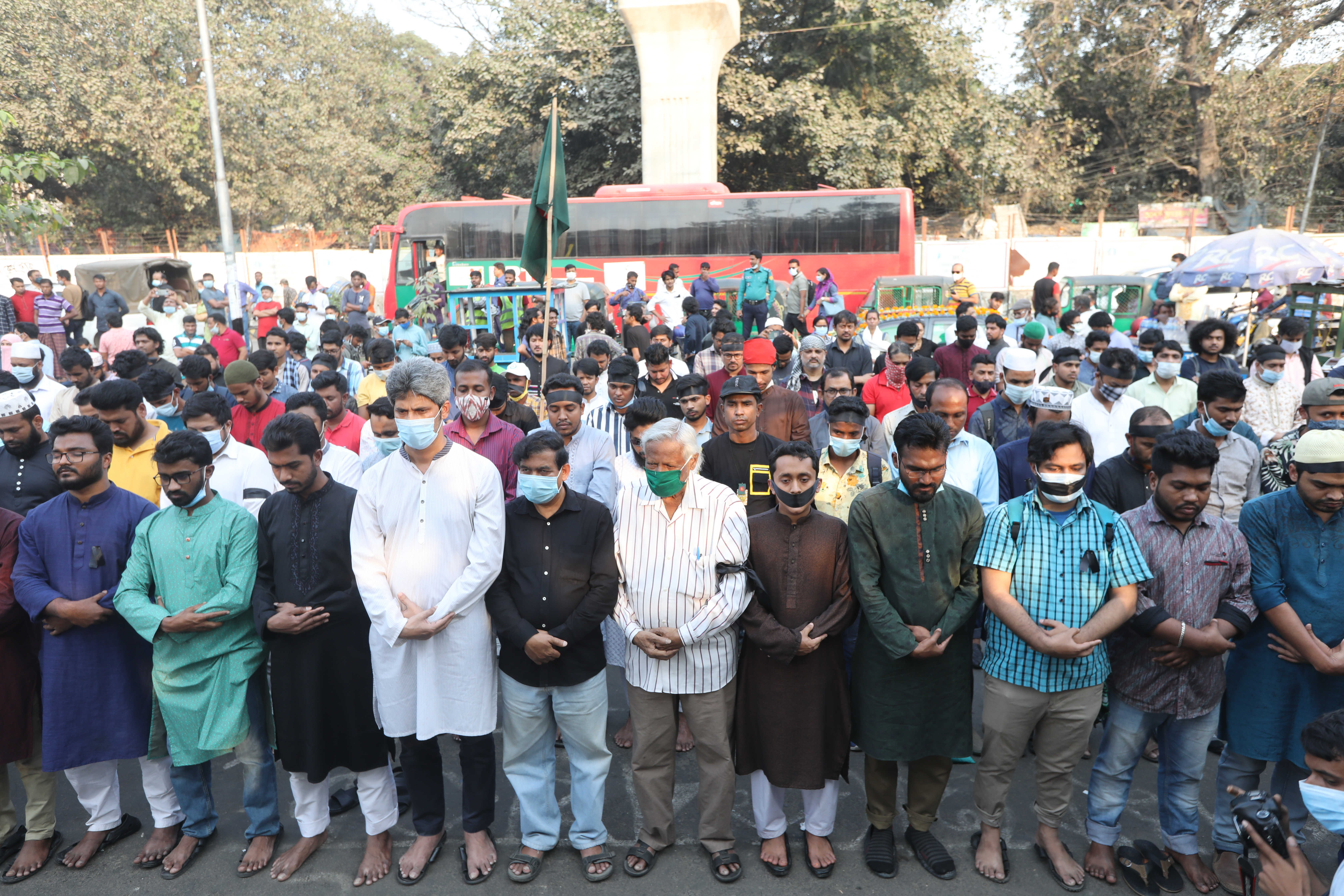 Prayers held on a street in Dhaka over Ahmed’s death
