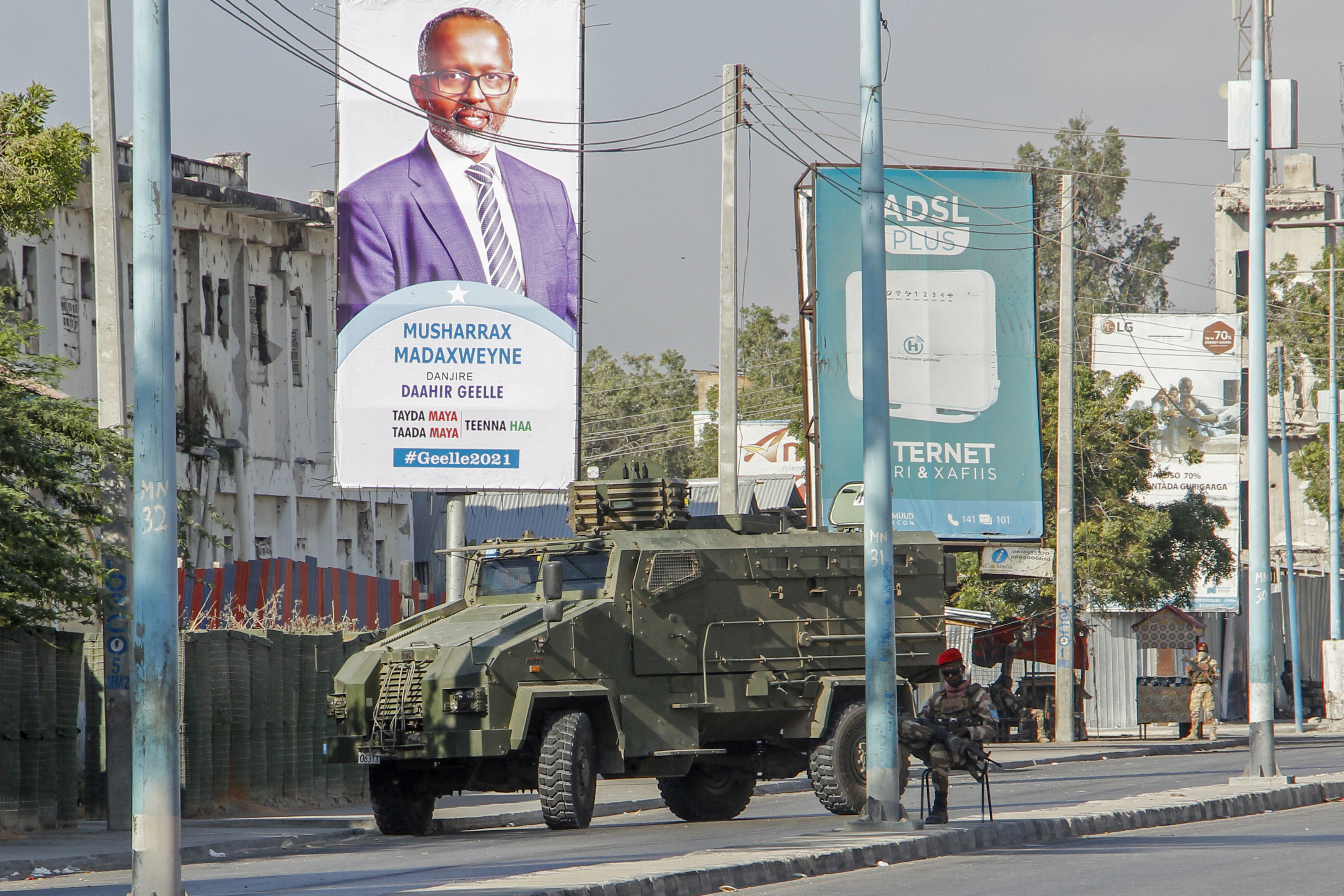 Security forces block a street with an armoured personnel carrier during protests against the government and the delay of the country's election in the capital Mogadishu, Somalia, Feb 19, 2021. [AP Photo]