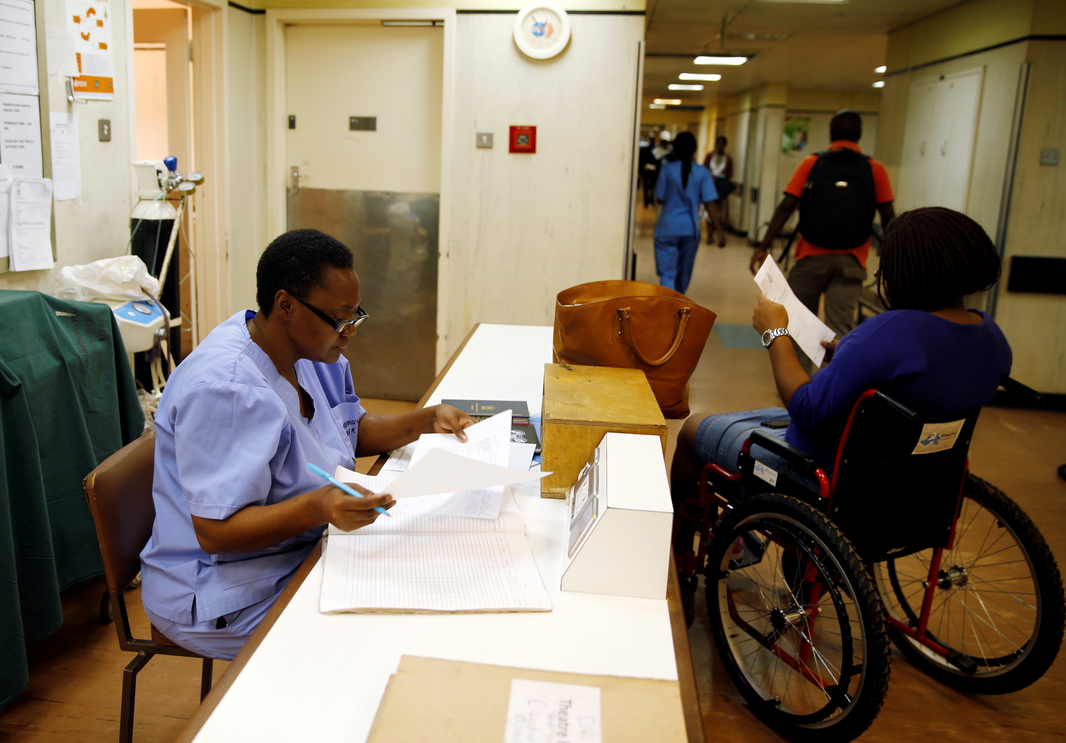 Medical staff assist a patient at a hospital in Harare