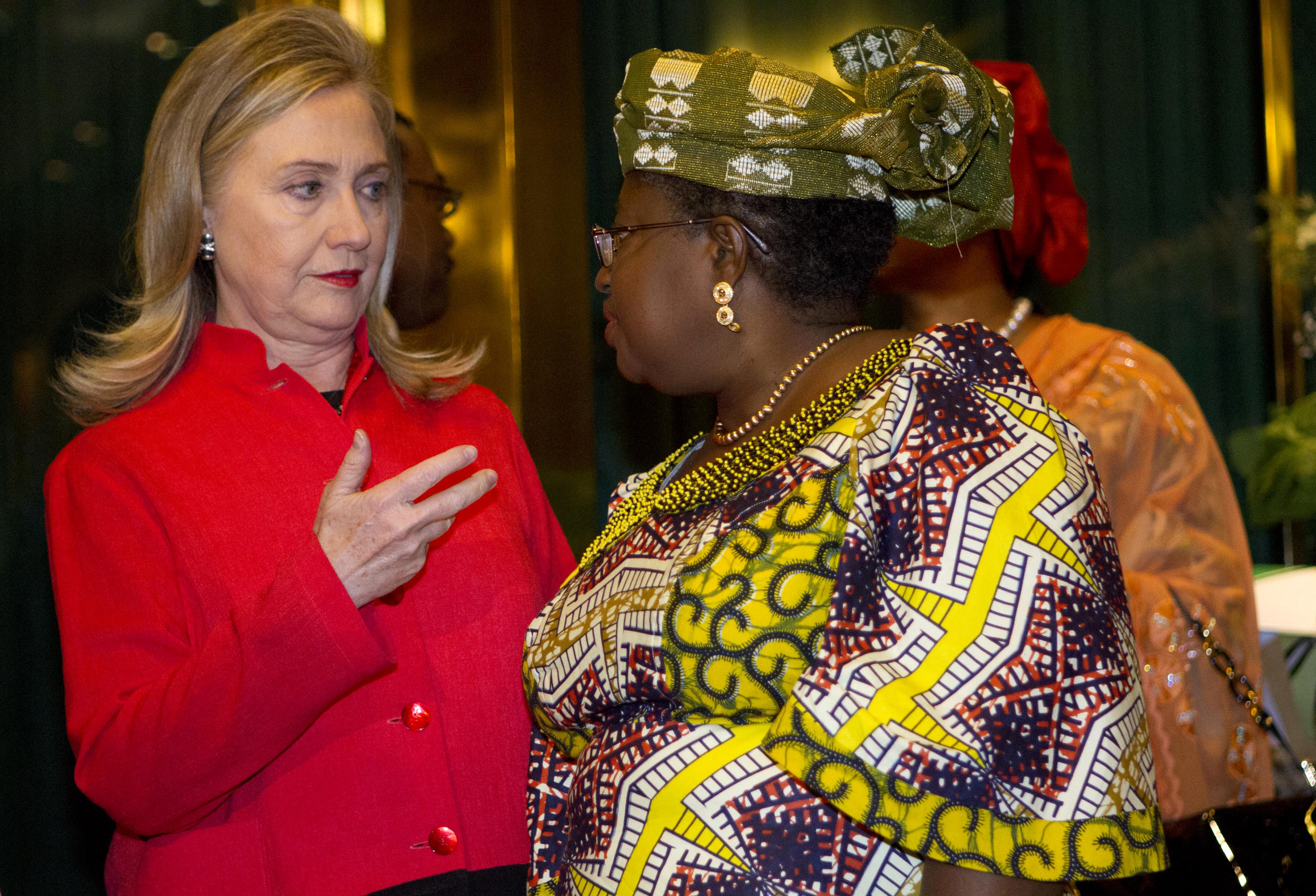Former United States Secretary of State Hillary Clinton speaks with Nigerian Finance Minister Ngozi Okonjo-Iweala at the Presidential Villa in Abuja, Nigeria