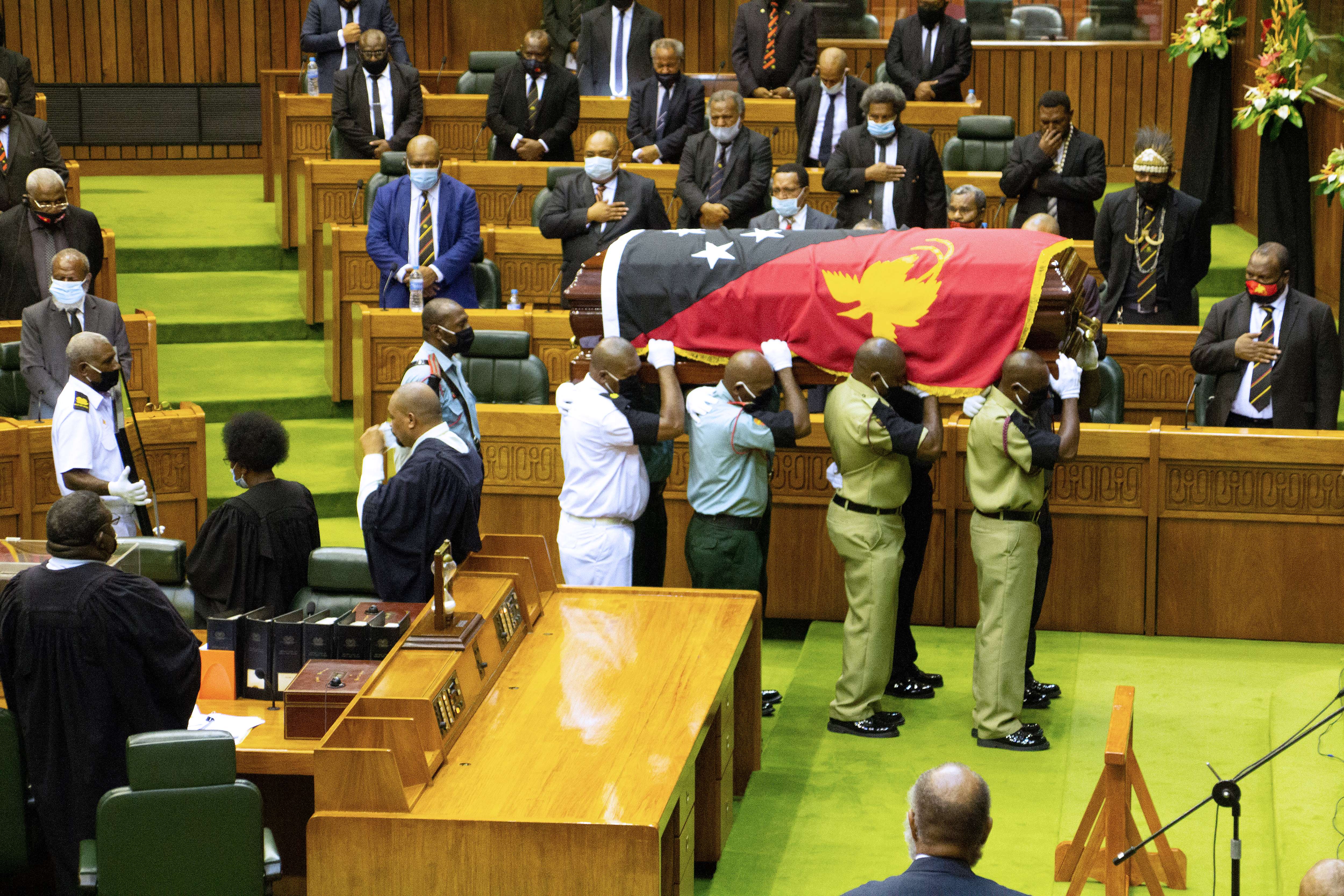Amid a surge in COVID-19 cases, the WHO is urging people attending this weekend's funeral for former Prime Minister Michael Somare to follow virus protocols [Andrew Kutan/AFP]