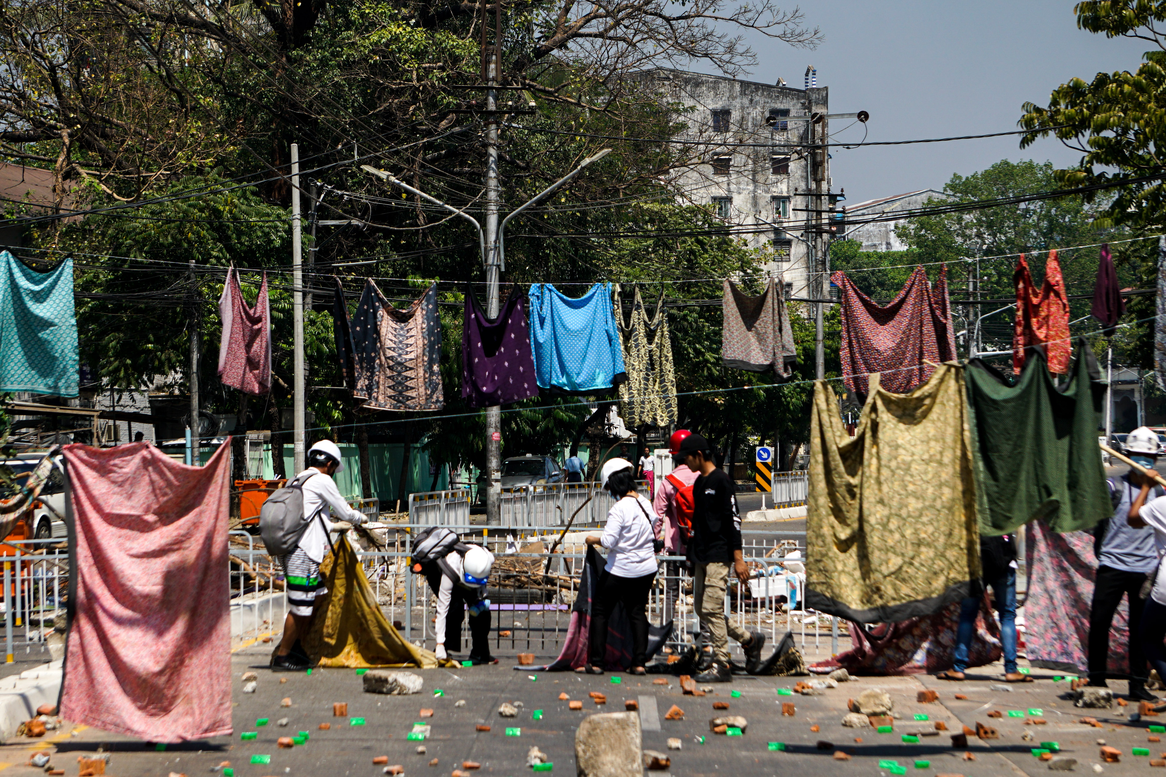 Protesters take part in an anti-coup protest as they hang women’s skirts to slow down the riot forces on International Women’s Day on March 8, 2021 in Yangon, Myanmar
