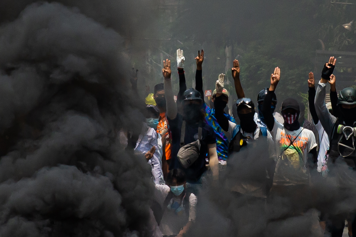 Smoke rises after protesters burn tyres as they protest against the military coup and detention of elected government members in Thakeyta township, Yangon, Myanmar on March 27, 2021