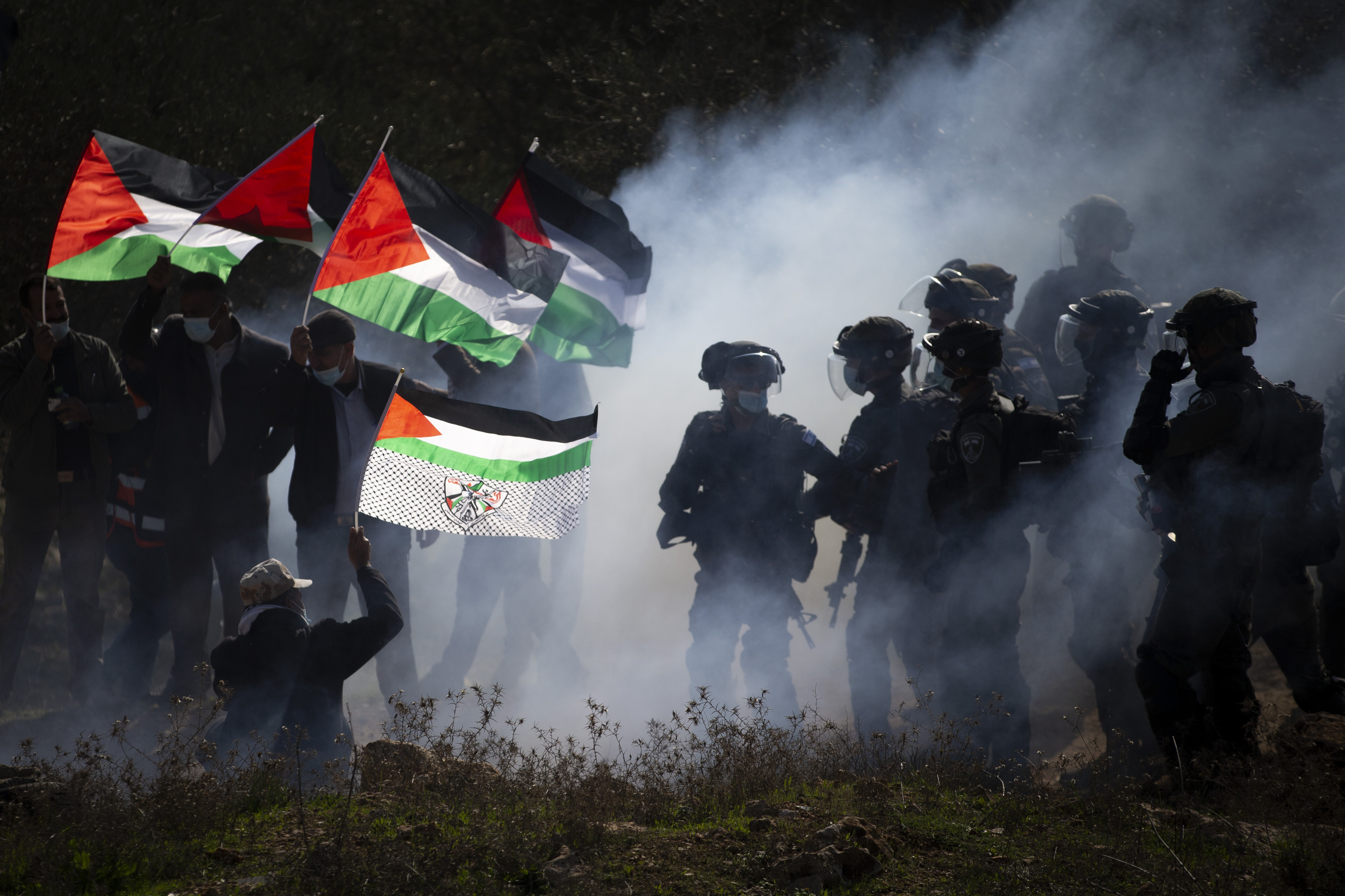 In this December 3, 2020 file photo, Israeli border police officers and Palestinians clash during a protest against the expansion of Israeli Jewish settlements near the West Bank town of Salfit [File: Majdi Mohammed/AP Photo]