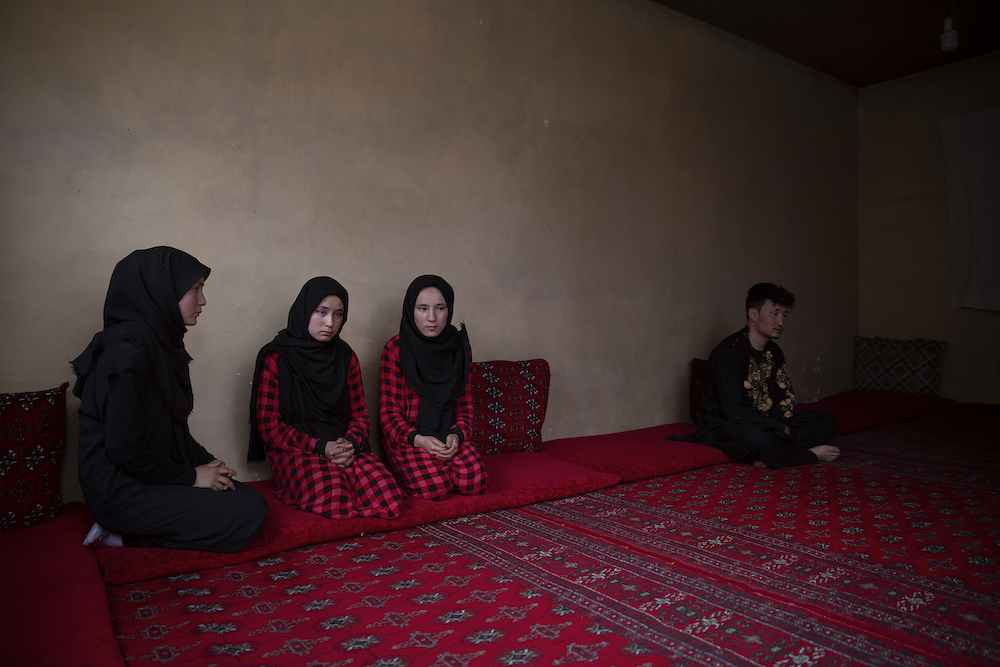 Farzana Azghari, in black, lost one of her sisters in the May attack on a girls’ school. Her two other sisters, in red, narrowly escaped the bombings