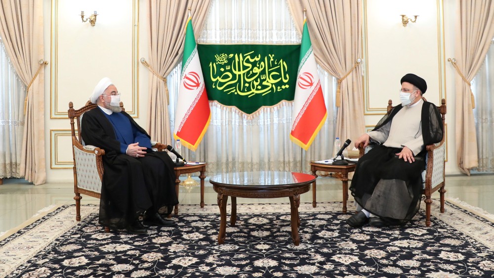 Iran’s outgoing President Rouhani meets with Iran’s President-elect Ebrahim Raisi in Tehran