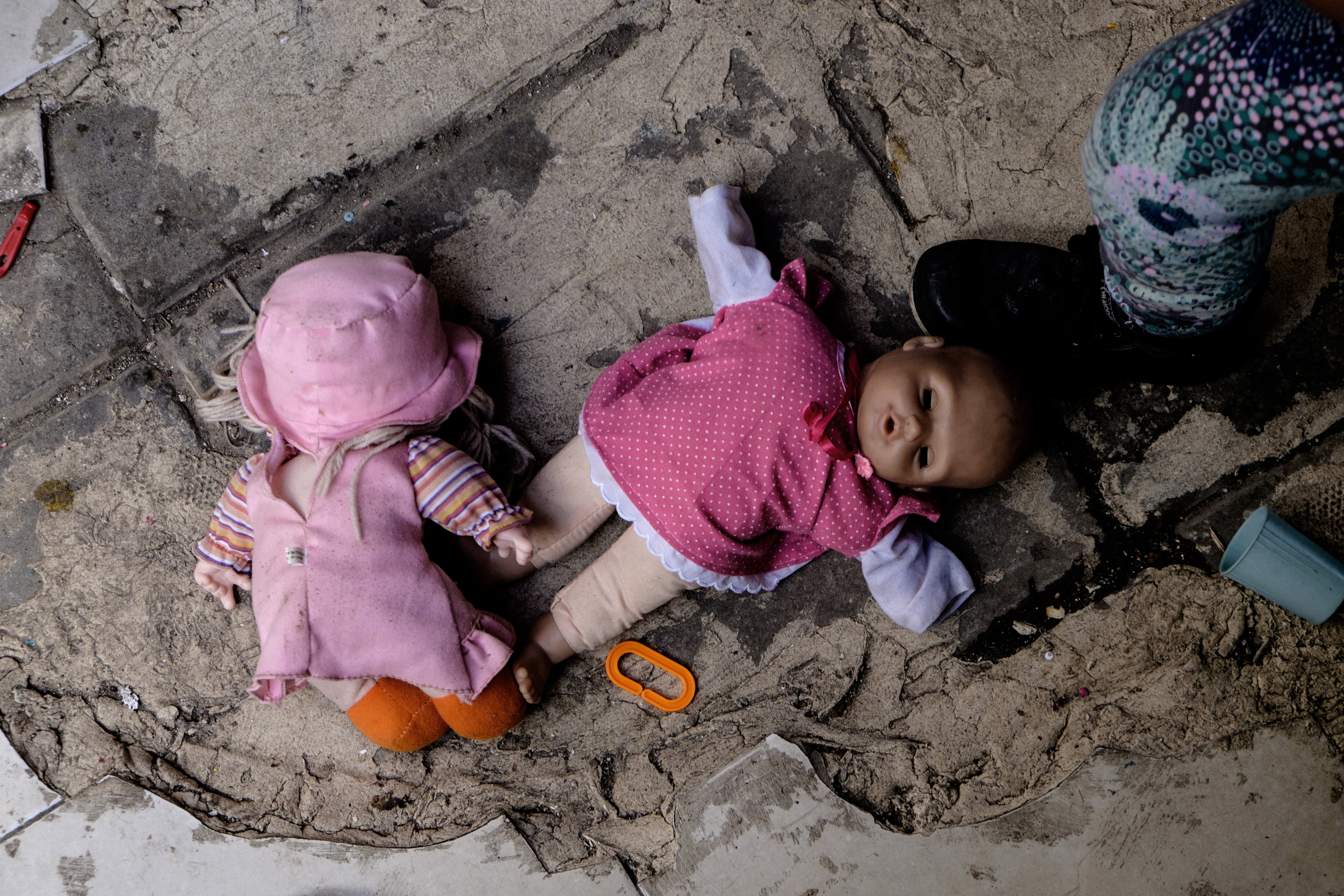 Dolls on the floor of a babysitter's home, where conditions can be unsanitary and unsafe [Photo courtesy of Elifelet]