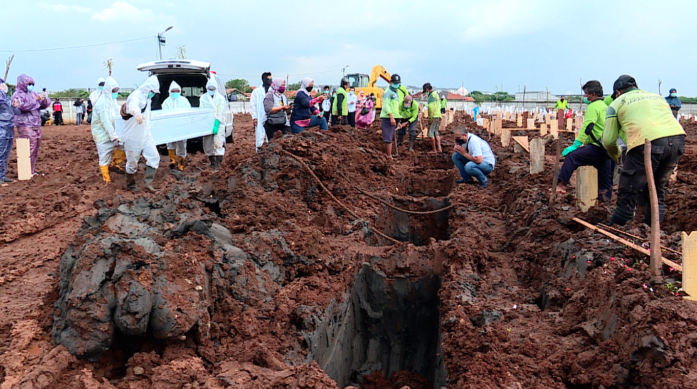 Cemetery workers prepare another burial as the coronavirus accelerates in Indonesia