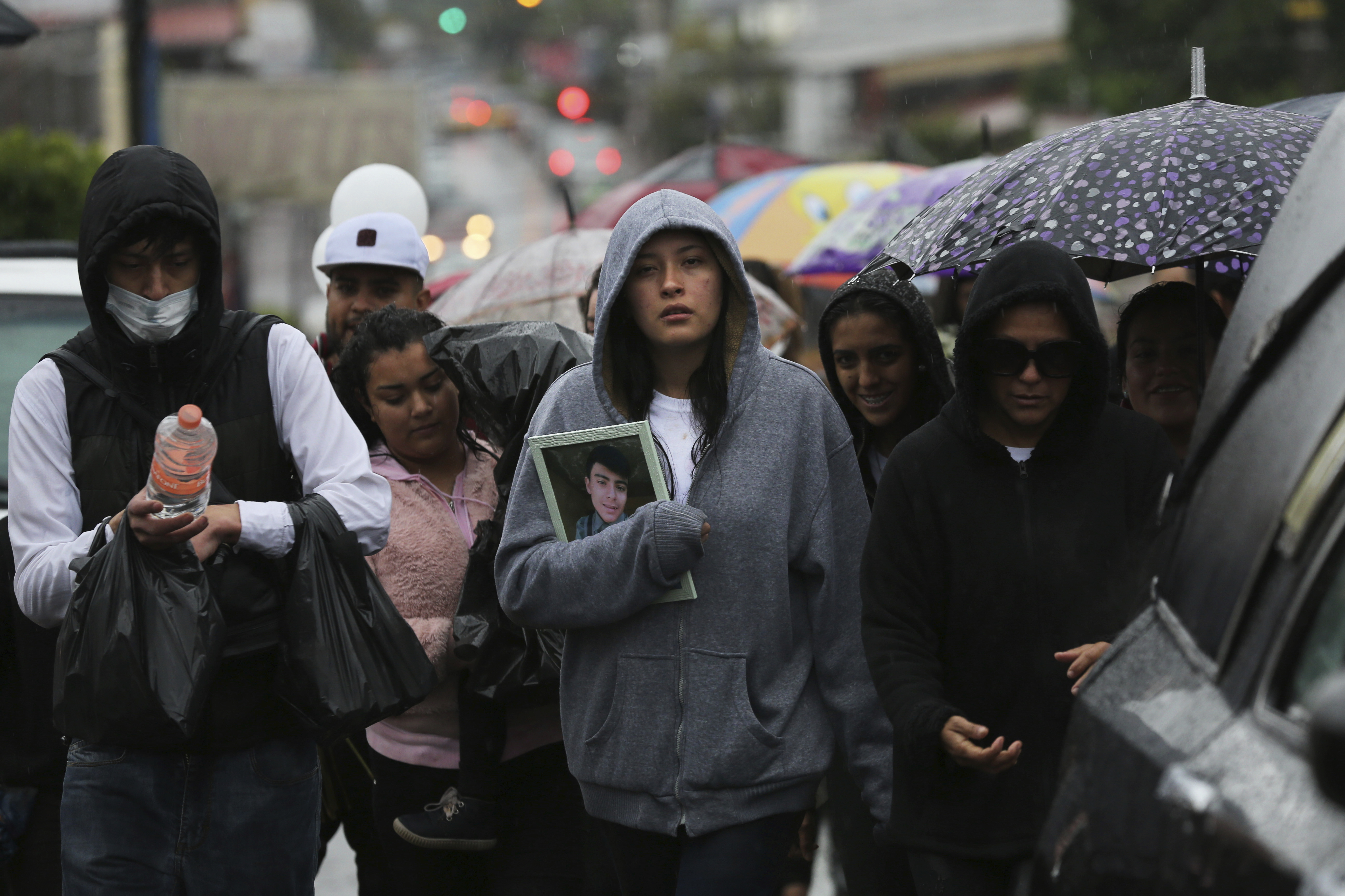 Family and friends attending the funeral procession for one of the victims of a shooting at a video-game arcade in Uruapan, Mexico
