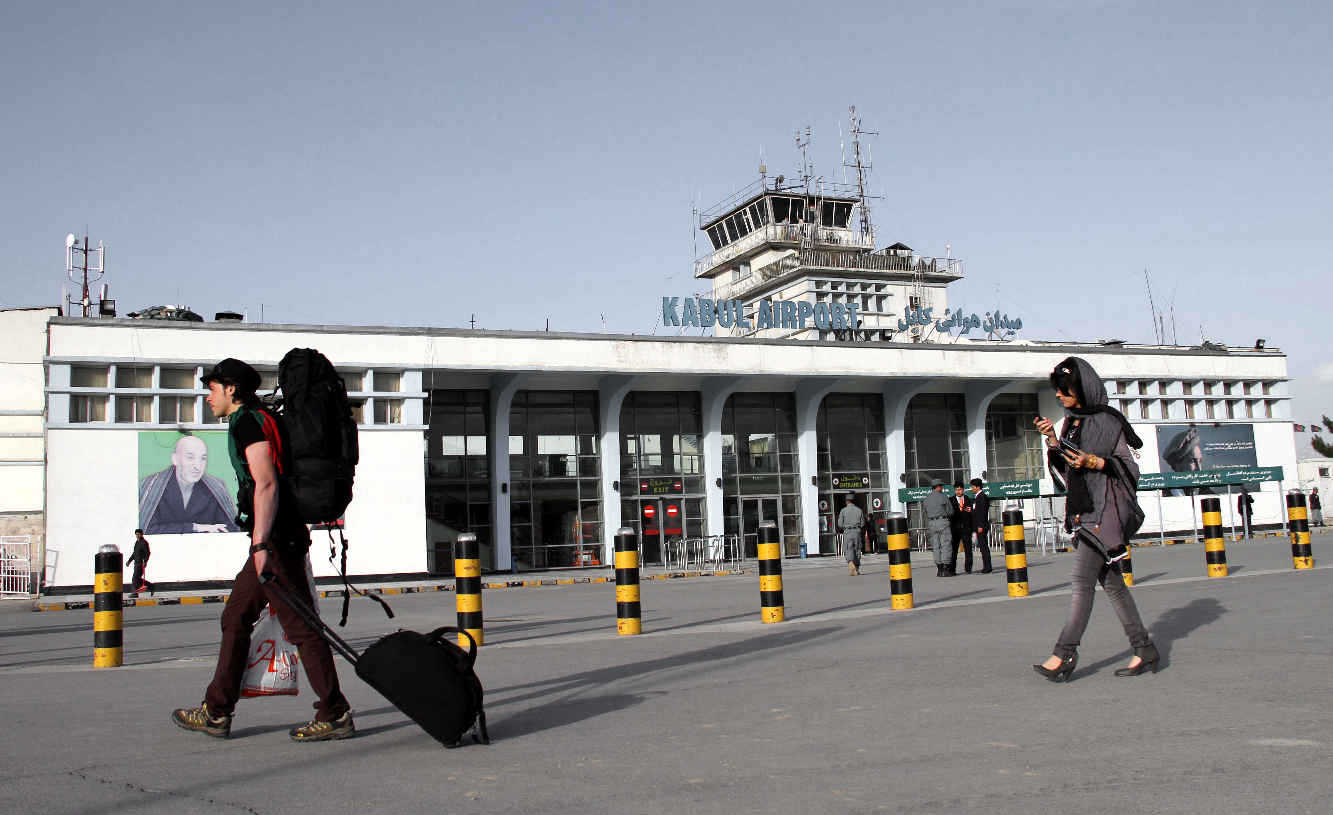 Travellers exit the Hamid Karzai International Airport in Kabul [File: S Sabawoon/EPA-EFE]