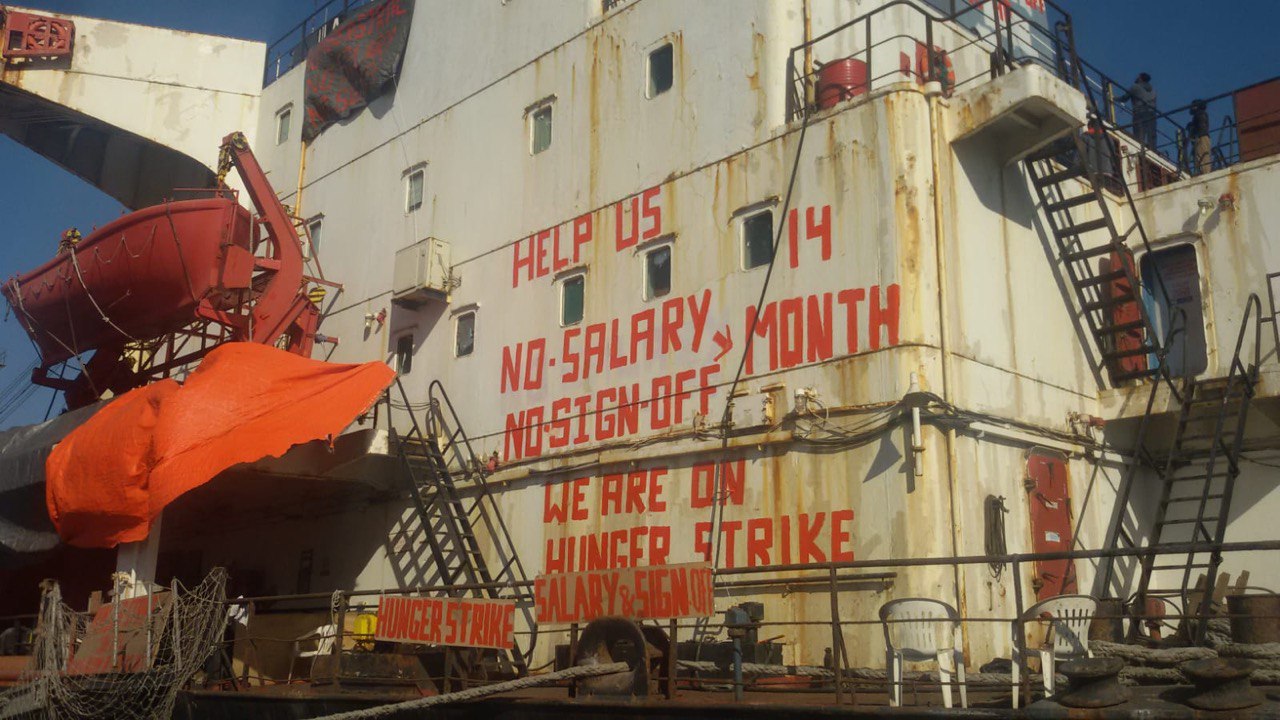Protests signs are seen onboard the Ula ship which was left abandoned by its owner [Al Jazeera]