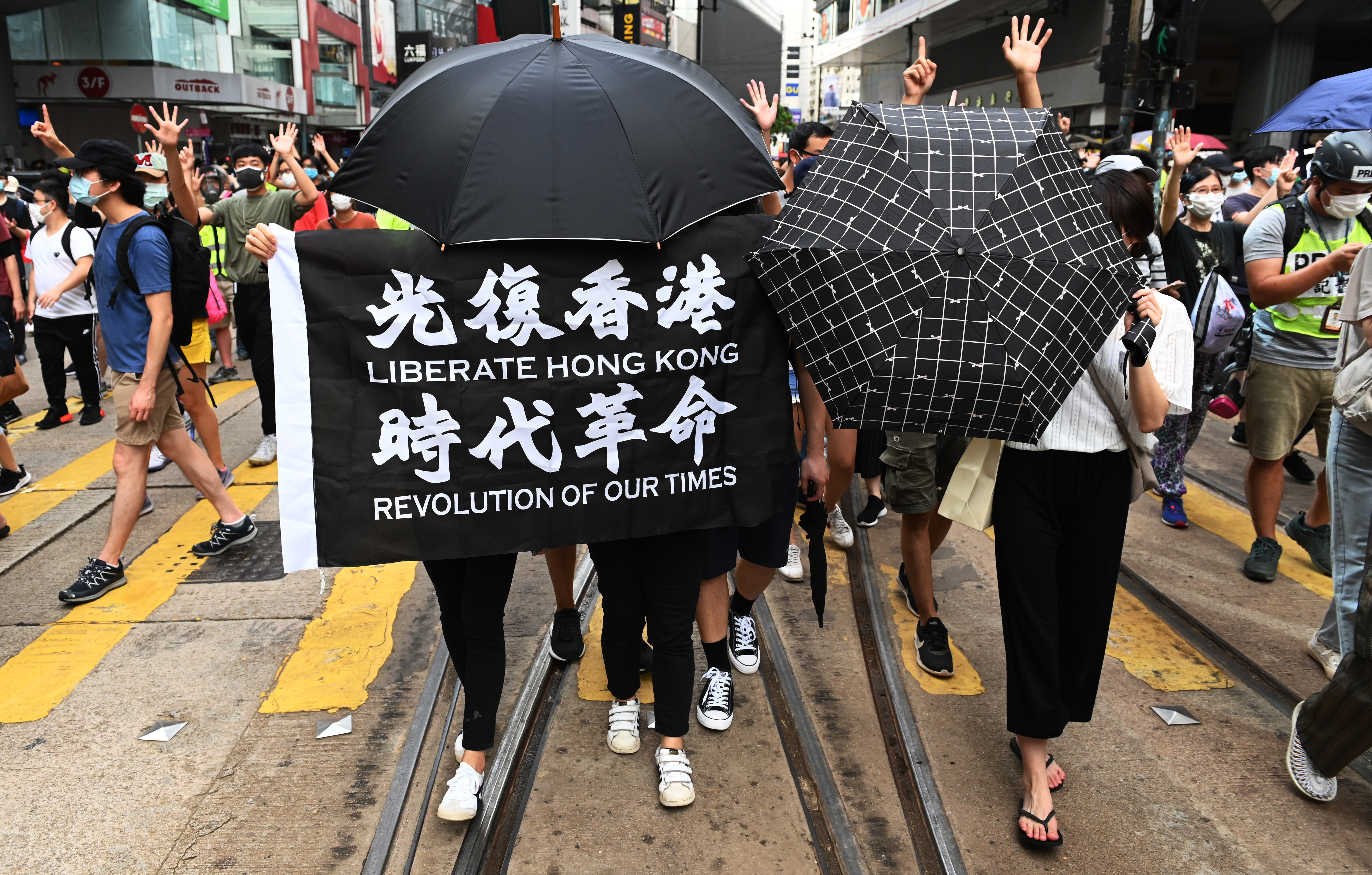 A court in Hong Kong will deliver its first decision in a national security law case on Tuesday with evidence hinging on the translation and meaning of the protest banner 'Liberate Hong Hong, Revolution of our Times' [File: Miguel Candela/EPA]