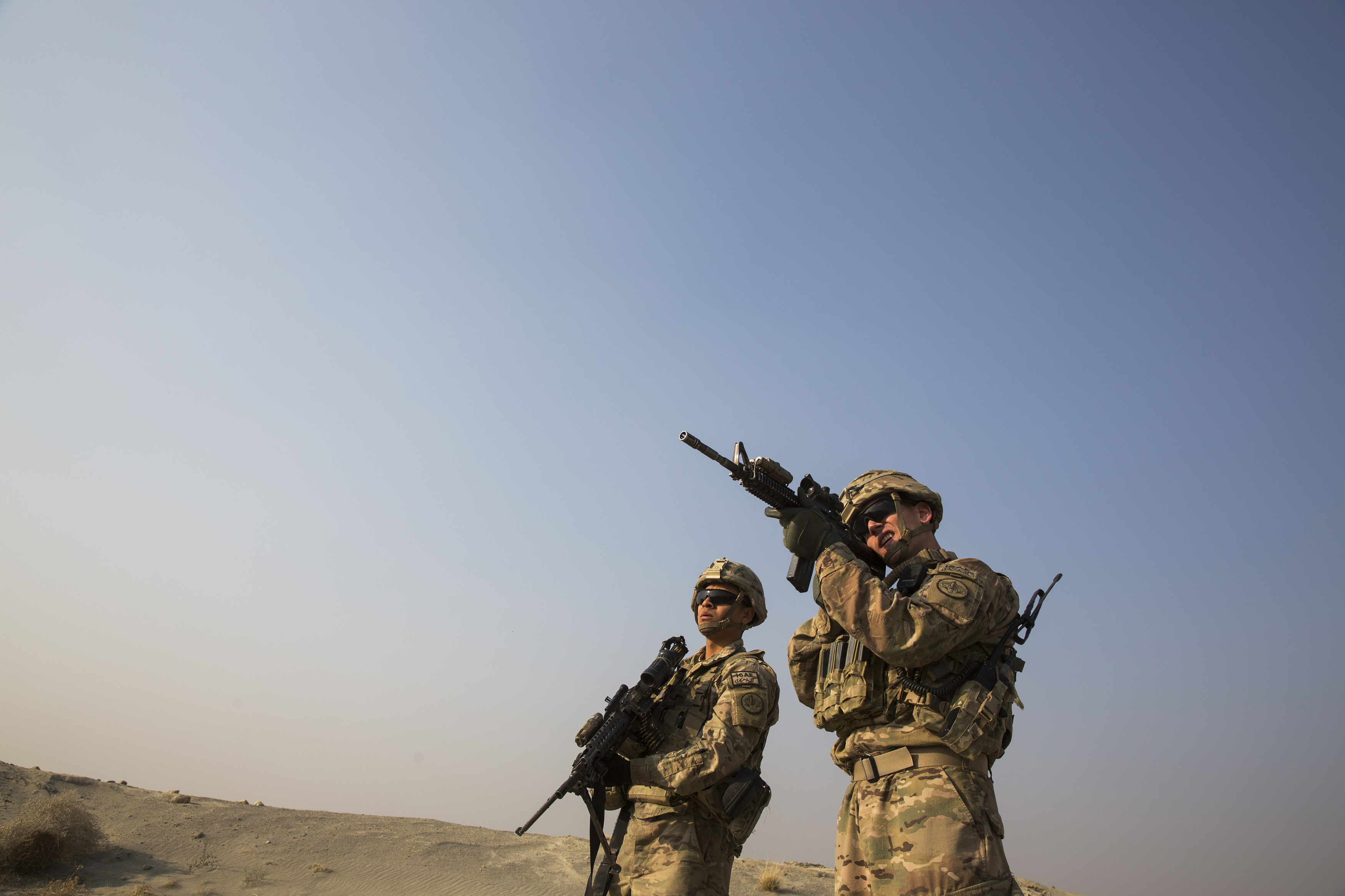 A US soldier from the 3rd Cavalry Regiment uses the optic on his rifle to observe Afghans in the distance, near forward operating base Gamberi, in the Laghman province of Afghanistan on December 15, 2014 [File: Reuters/Lucas Jackson]