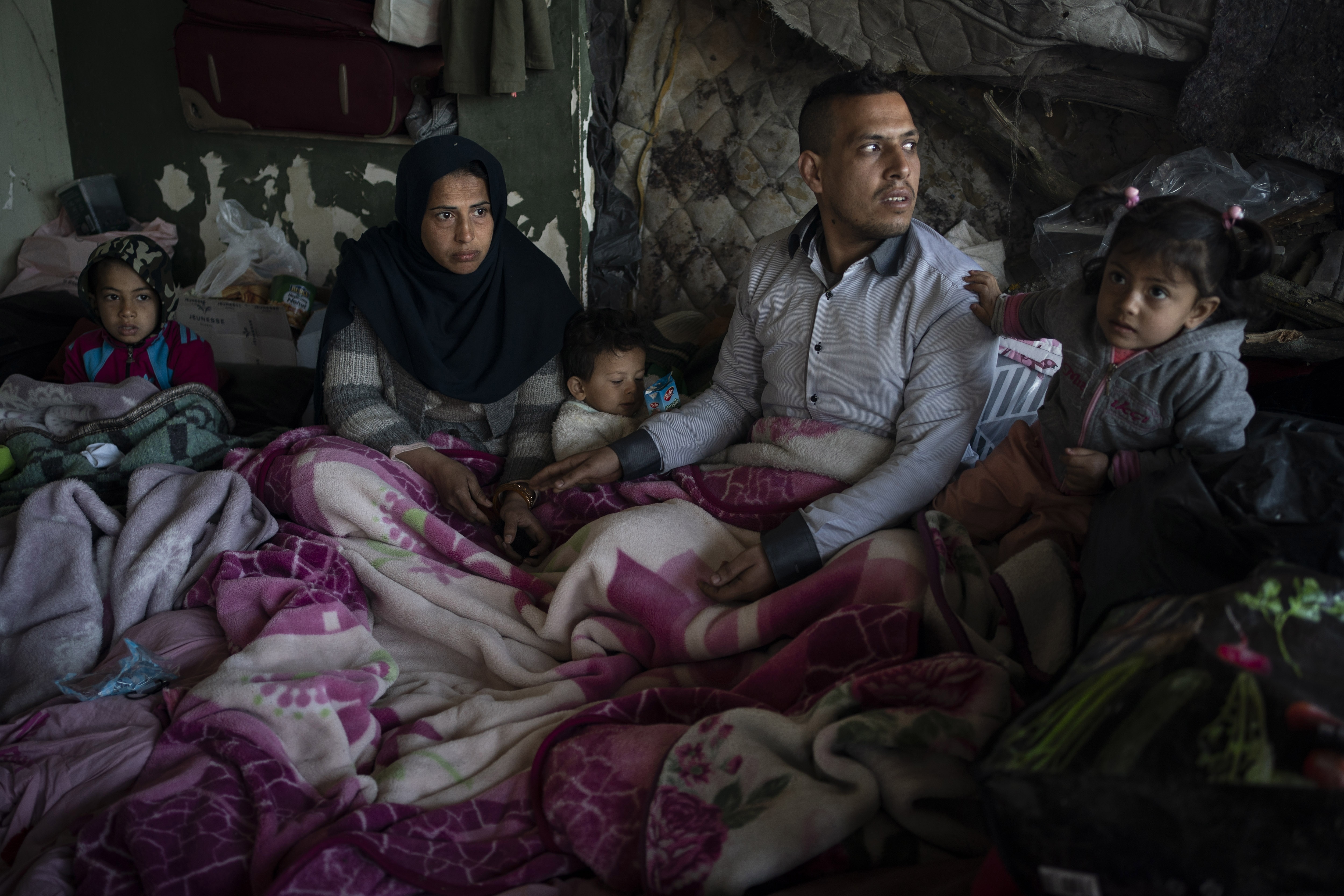 A family from Afghanistan gather at an abandoned building in Edirne, near the Turkish-Greek border