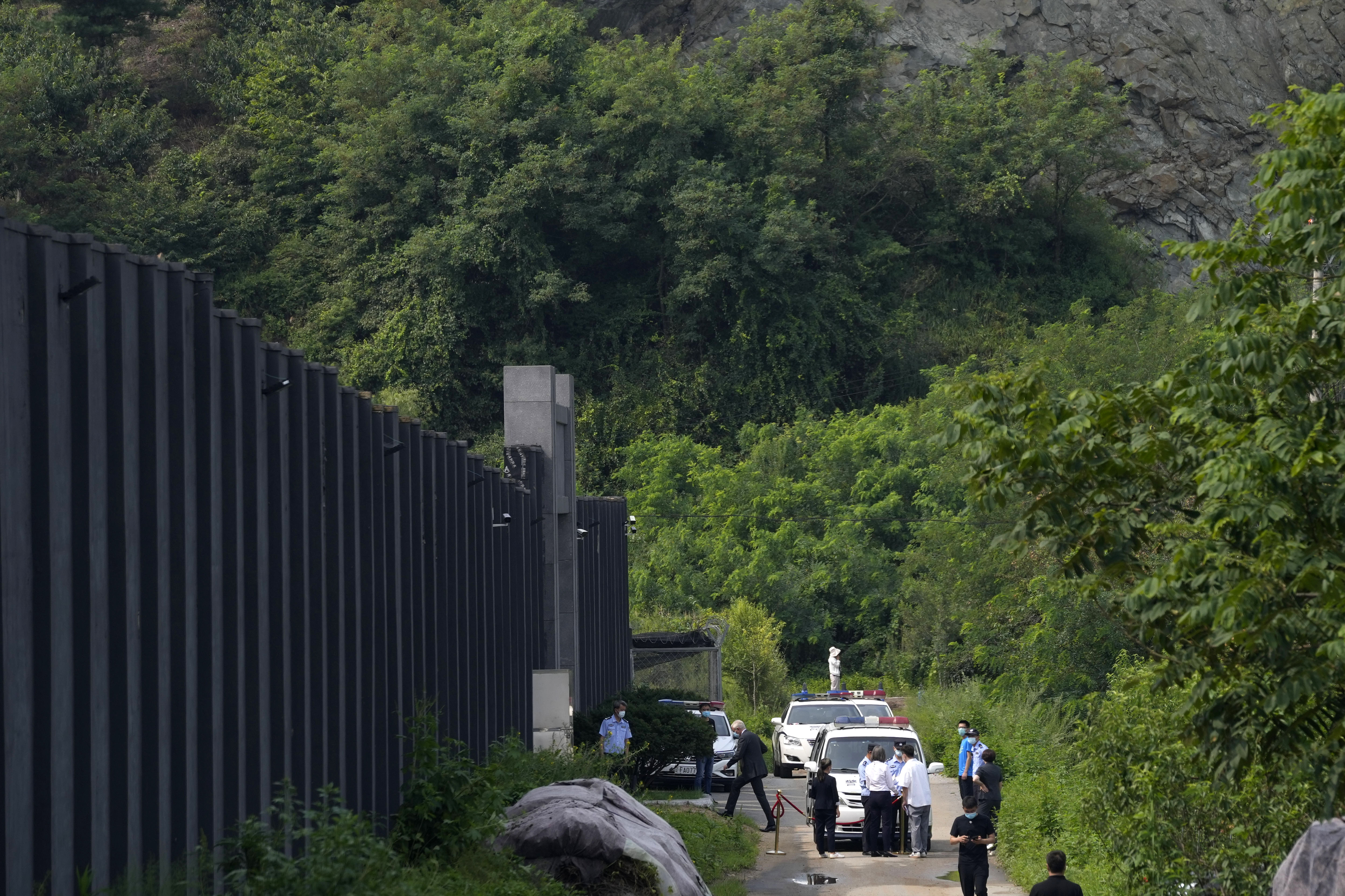 Dominic Barton, third from left, Canada’s ambassador to China, walks into a Dandong detention centre to meet Canadian Michael Spavor