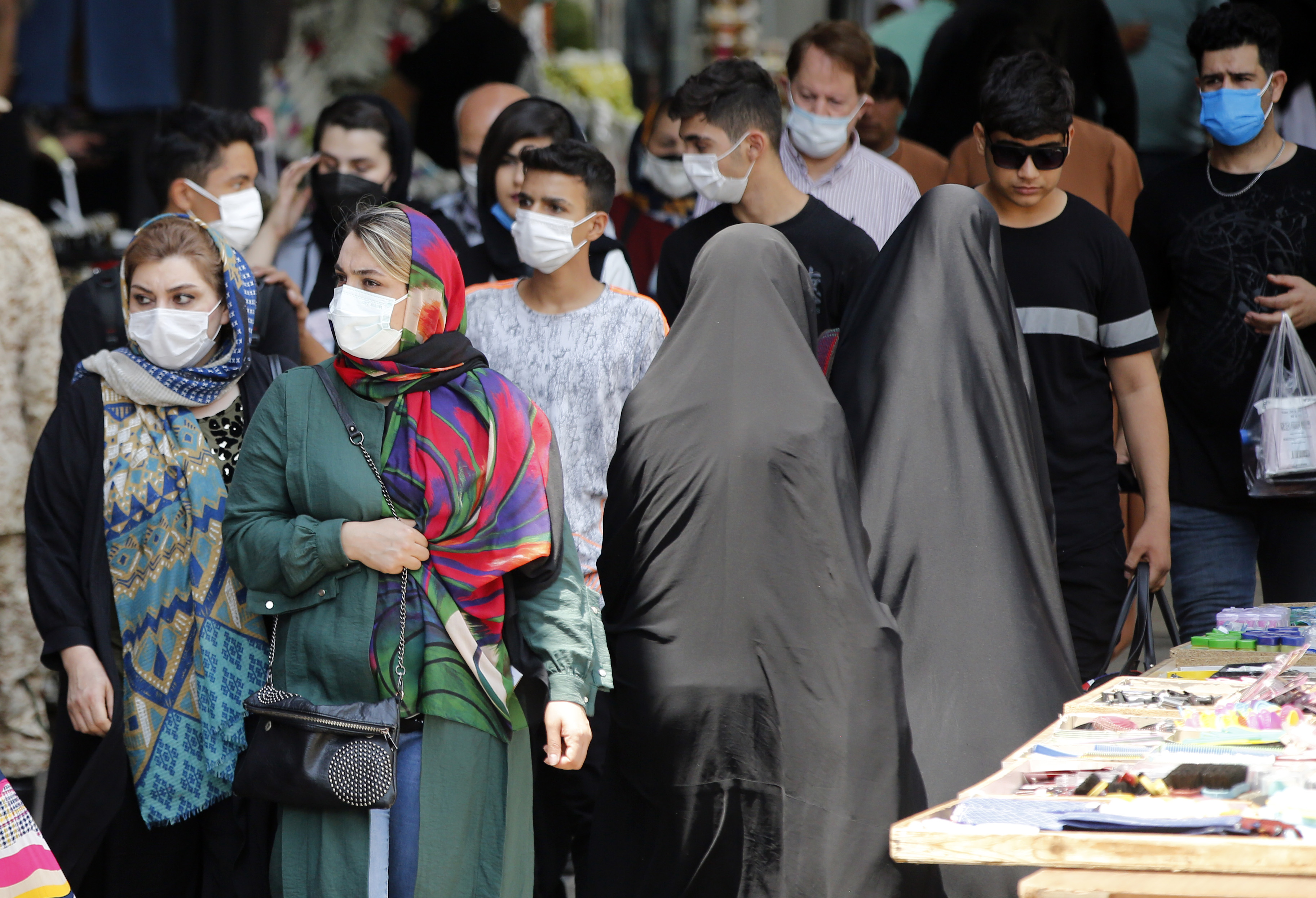 Iranian women wearing face masks walk around the Tajrish Bazaar in Tehran , Iran, 20 July 2021