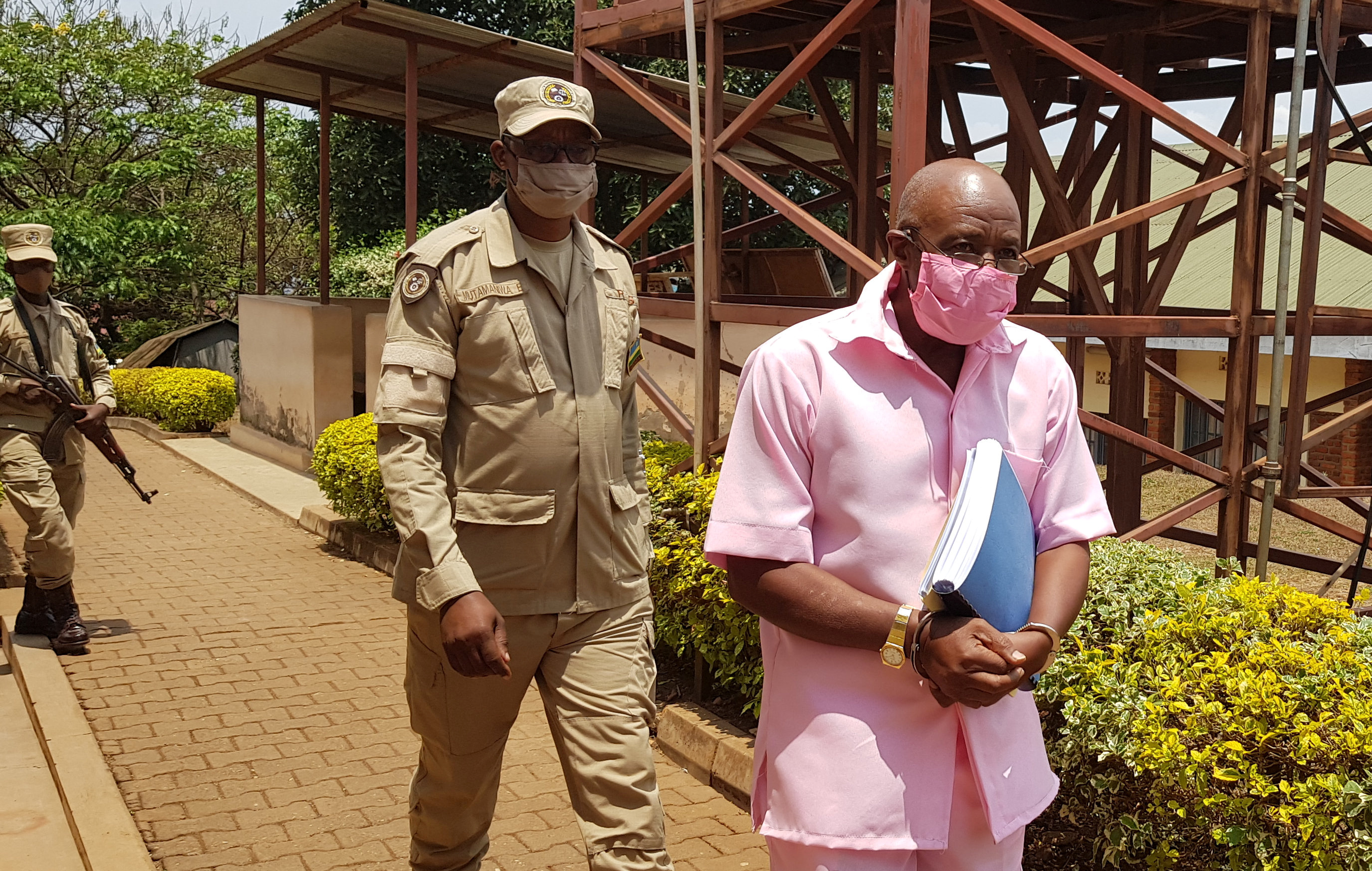 Paul Rusesabagina, portrayed as a hero in a Hollywood movie about Rwanda's 1994 genocide, is escorted in handcuffs from the courtroom in Kigali, Rwanda September 25, 2020