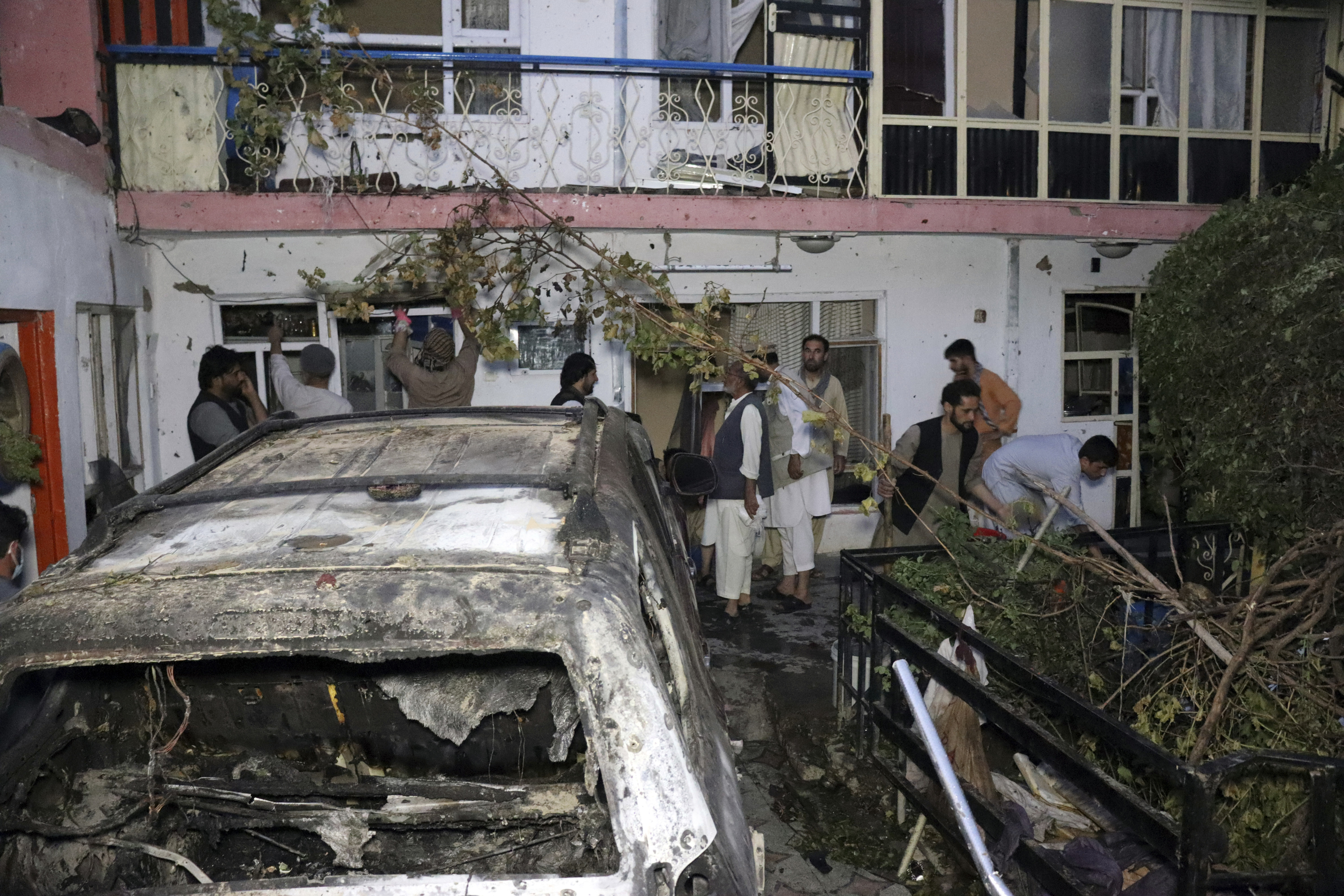 In this Aug. 29, 2021 file photo, Afghans are seen as they inspect a house damaged by a US drone strike which killed 10 members of a family, including many children, in Kabul, Afghanistan [AP Photo/Khwaja Tawfiq Sediqi, File]