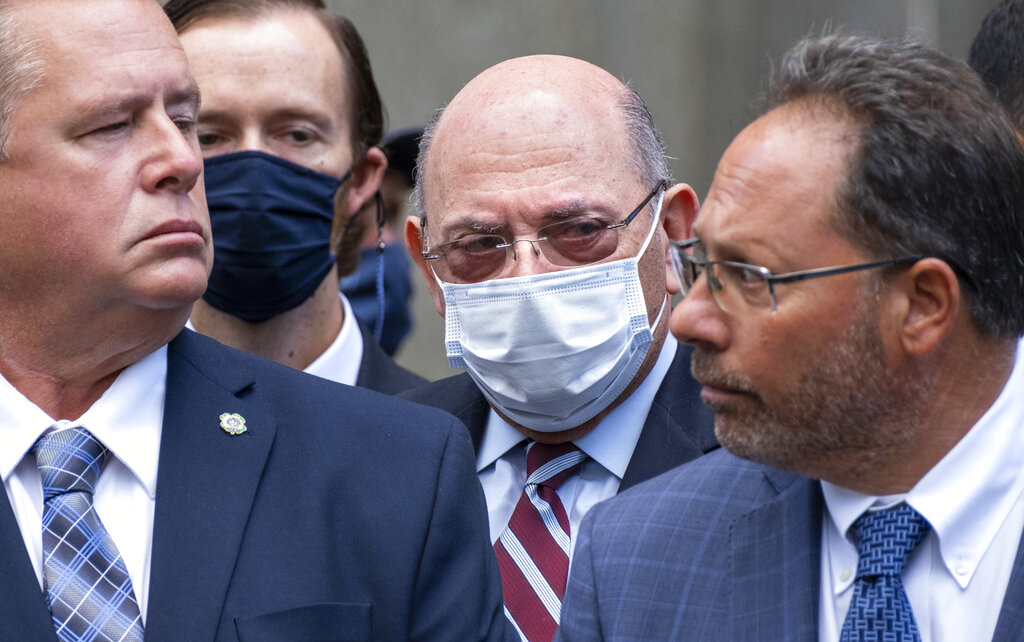 The Trump Organization’s Chief Financial Officer Allen Weisselberg, centre, awaits a car after leaving a courtroom appearance in New York