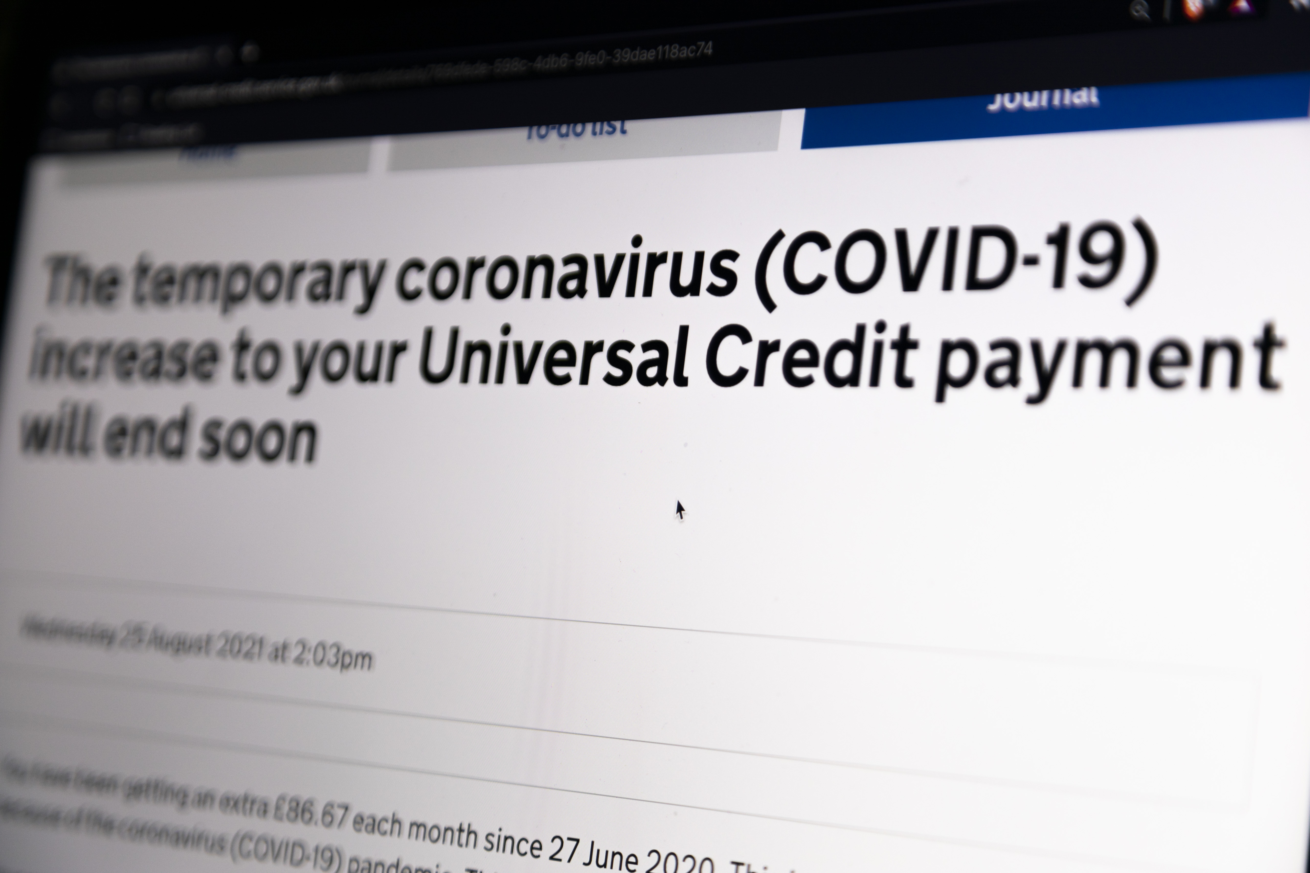 In this photo illustration, a laptop screen shows a notice to a benefits recipient that the temporary coronavirus (COVID-19) increase to their Universal Credit payment will be removed by the end of September on 5th September, 2021 in Leeds, United Kingdom. British Chancellor Rishi Sunak is set to remove the 20-pound-a-week uplift to Universal Credit recipients in a move that critics have said will force the country's poorest further into poverty. [Daniel Harvey Gonzalez/In Pictures via Getty Images]