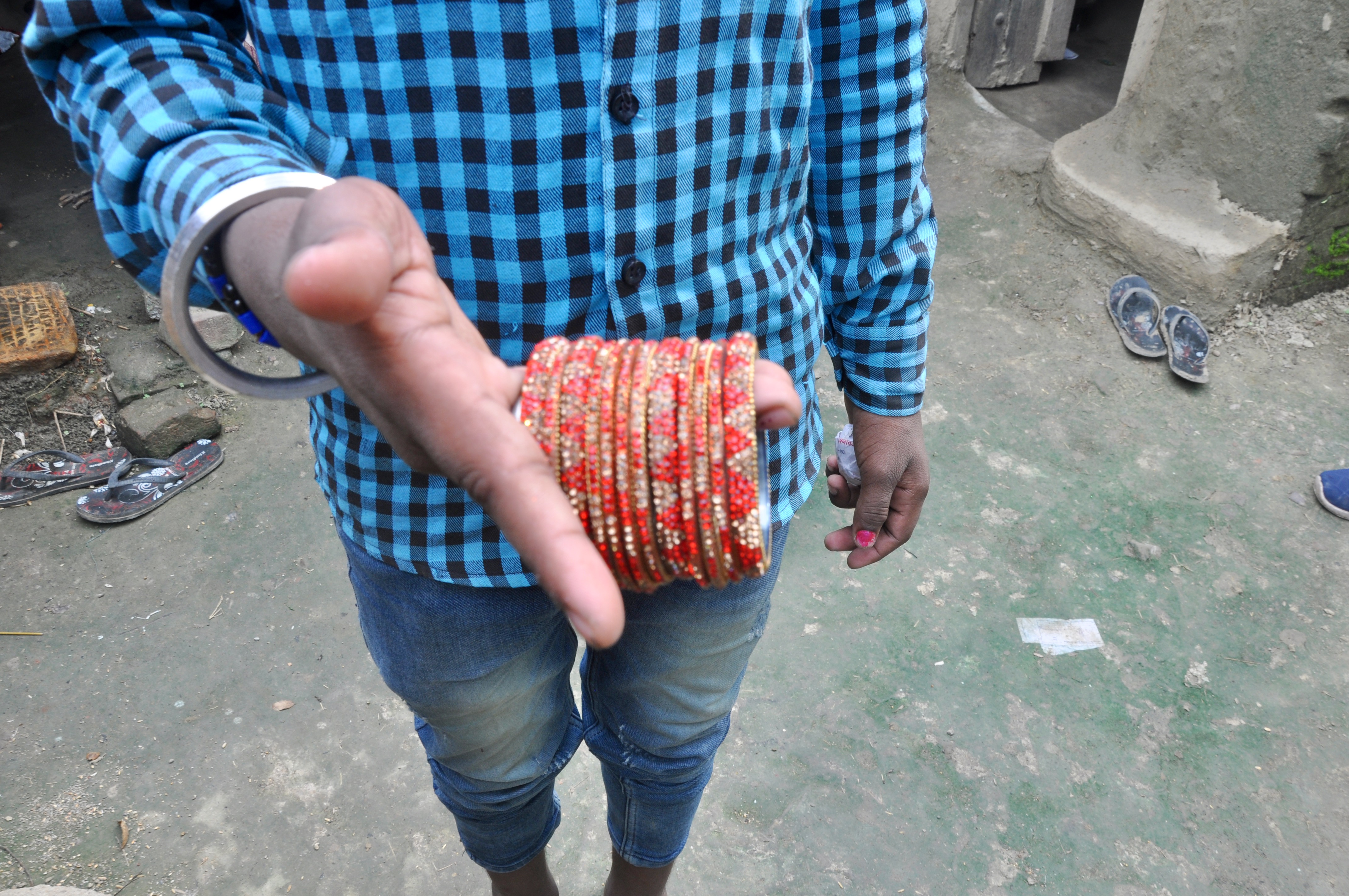 A rescued teenager in Bandi village in Gaya district’s Neemchak Bathani block shows a set of bangles he brought back. Most factories expect a child labourer to make 250-300 such bangles every day