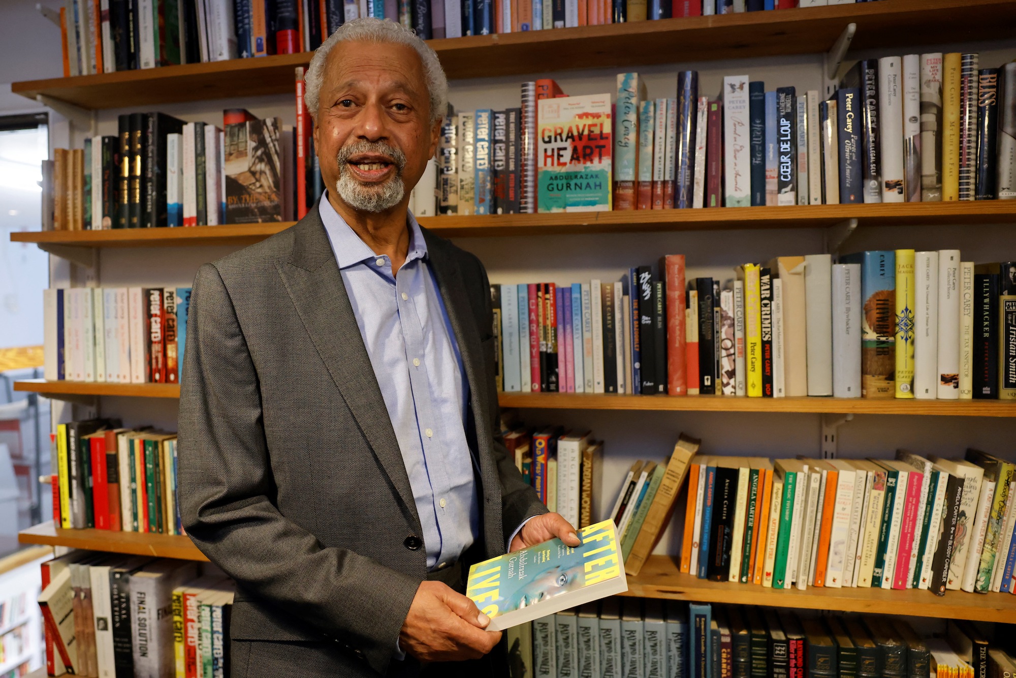 Zanzibar-born author Abdulrazak Gurnah poses for a photo call prior to attending a press conference, after he was awarded the Nobel Prize for literature, in London on October 8, 2021 [Tolga Akmen/ AFP]