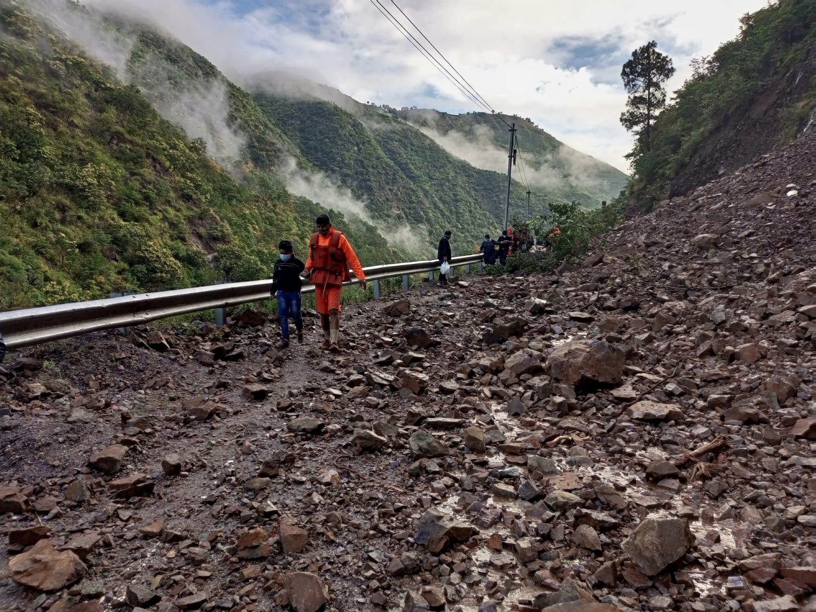 Members of India’s National Disaster Response Force (NDRF) evacuate stranded people following heavy rains at Chhara village in Nainital district, Uttarakhand state [NDRF handout via Reuters]