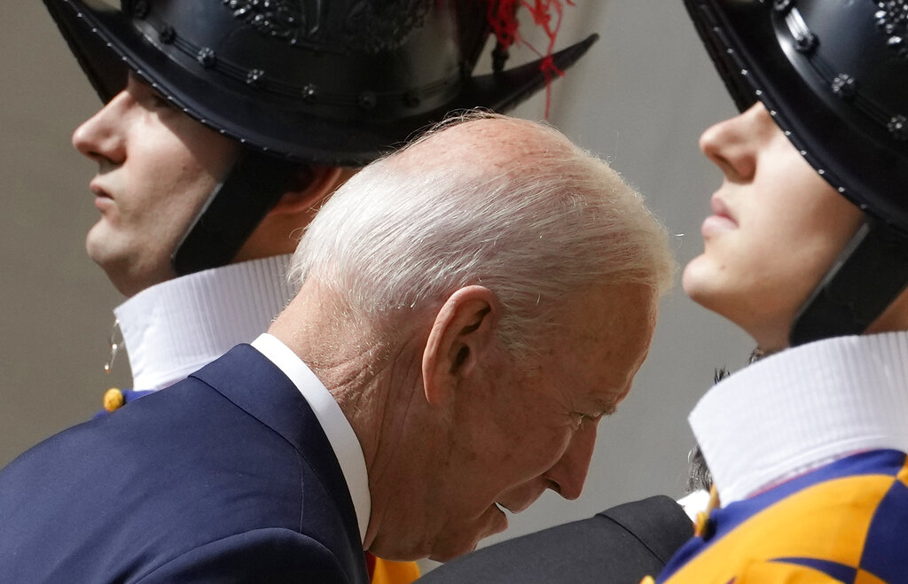 US President Joe Biden, flanked by Swiss Guards, arrives for a meeting with Pope Francis at the Vatican