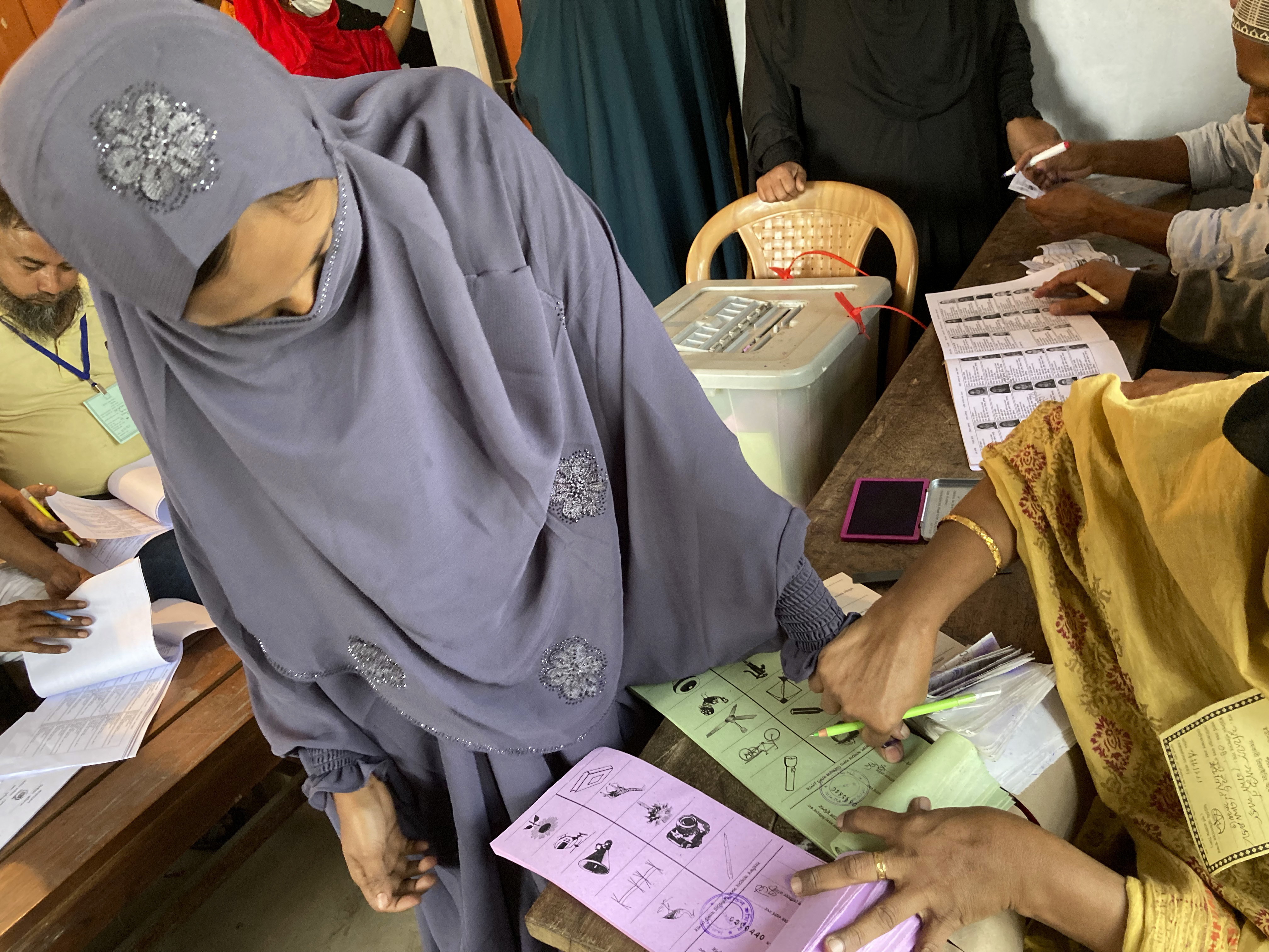 A voter gives her thumb imprint before proceeding to vote at a polling centre in Srinagar, Munshiganj district, Bangladesh