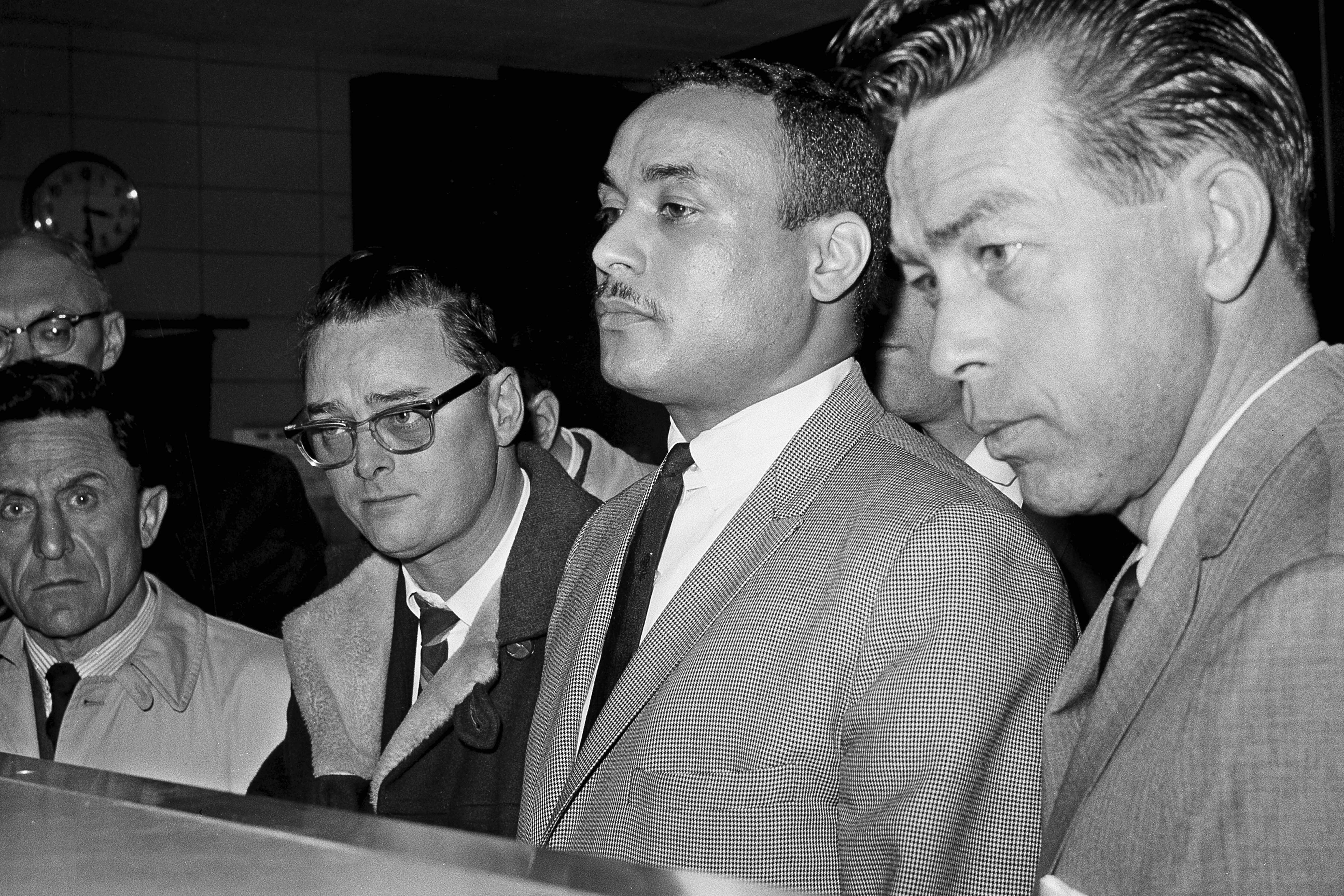 Khalil Islam, centre, is booked as the third suspect in the slaying of Malcolm X, in New York, March 3, 1965. Islam, previously known as Thomas 15X Johnson, is set to be cleared after more than half a century