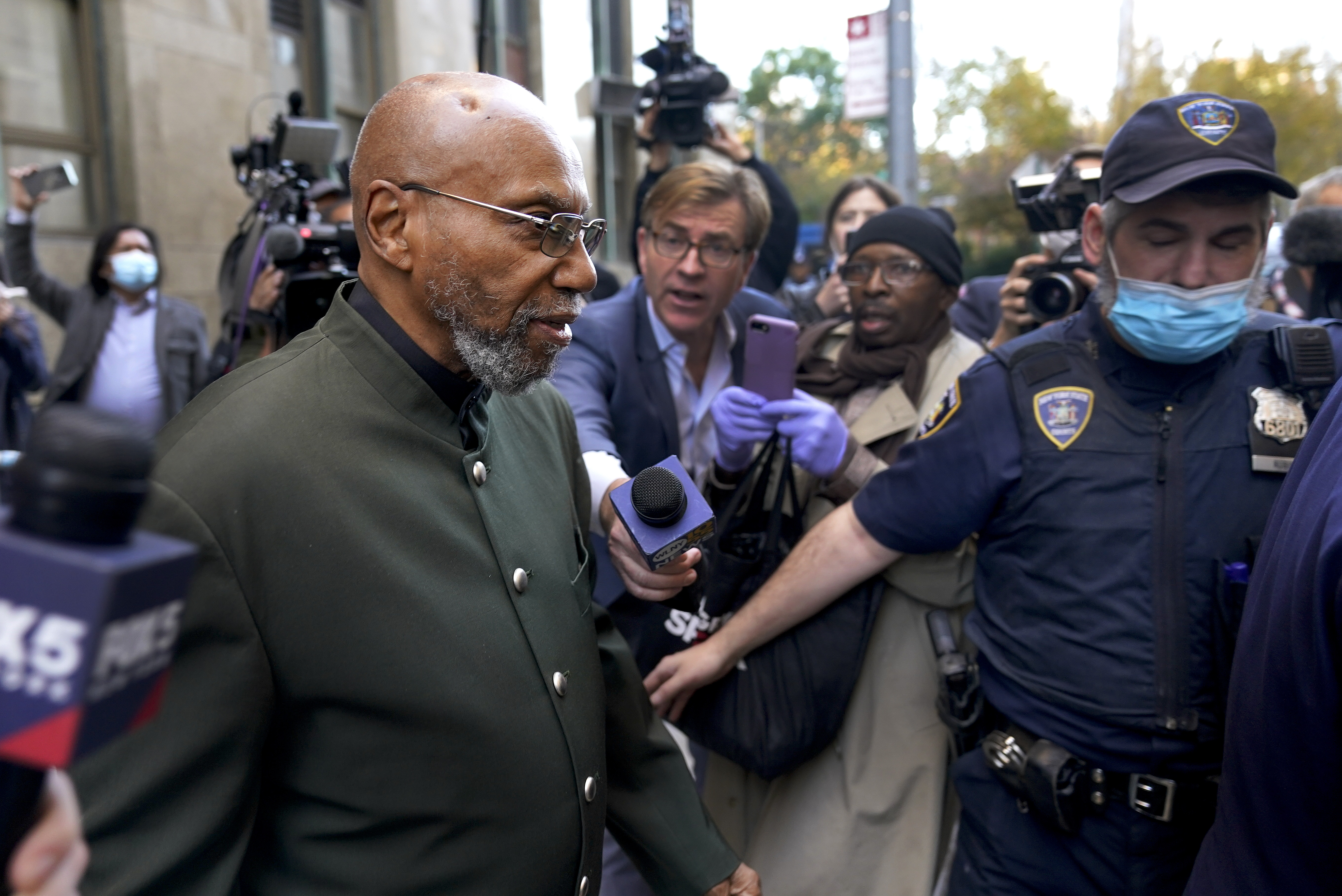 Muhammad Aziz walks out of a New York court after his conviction in the killing of Malcolm X was vacated on November 18, 2021 [AP/Seth Wenig]