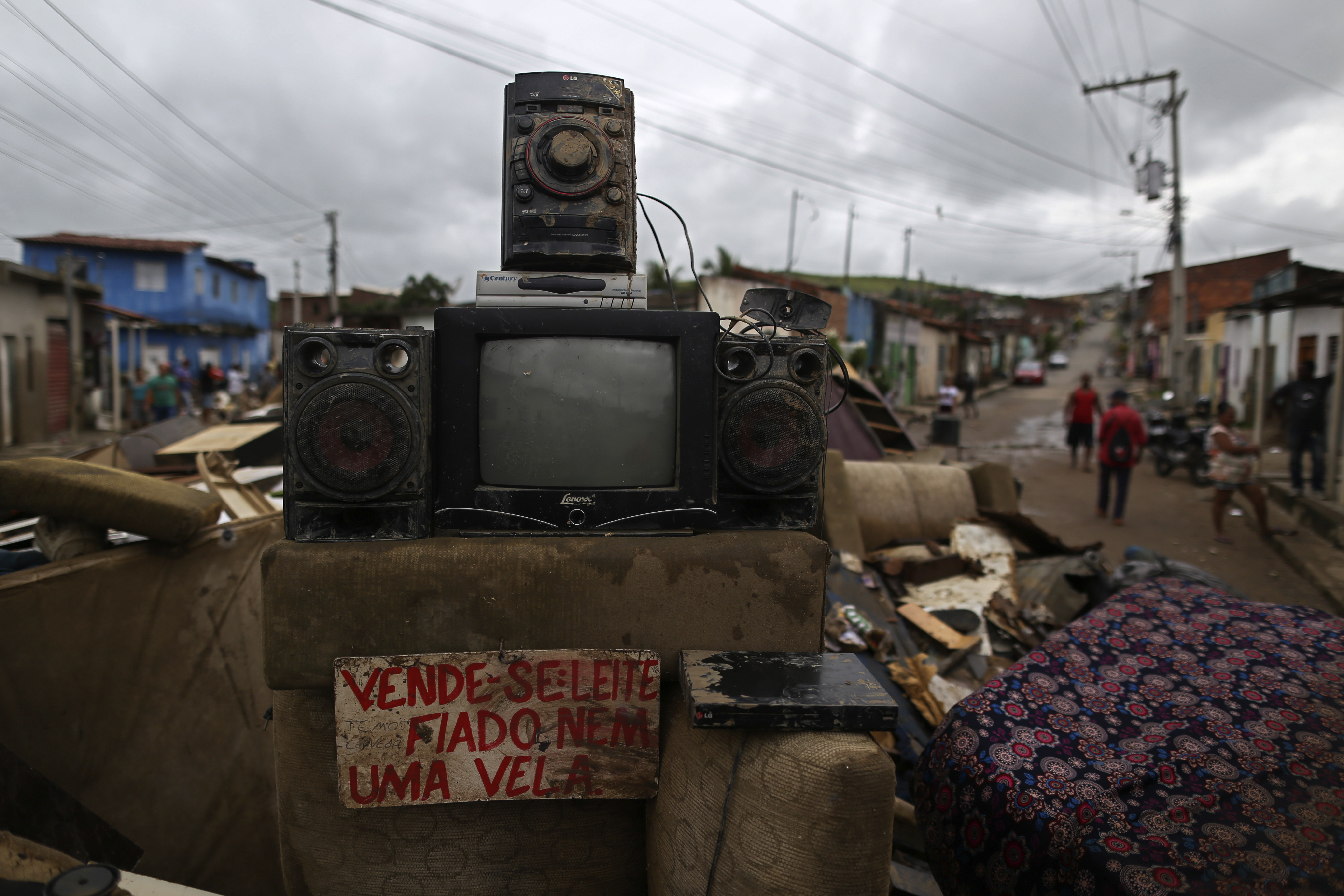 Furniture destroyed by flooding is piled in a street