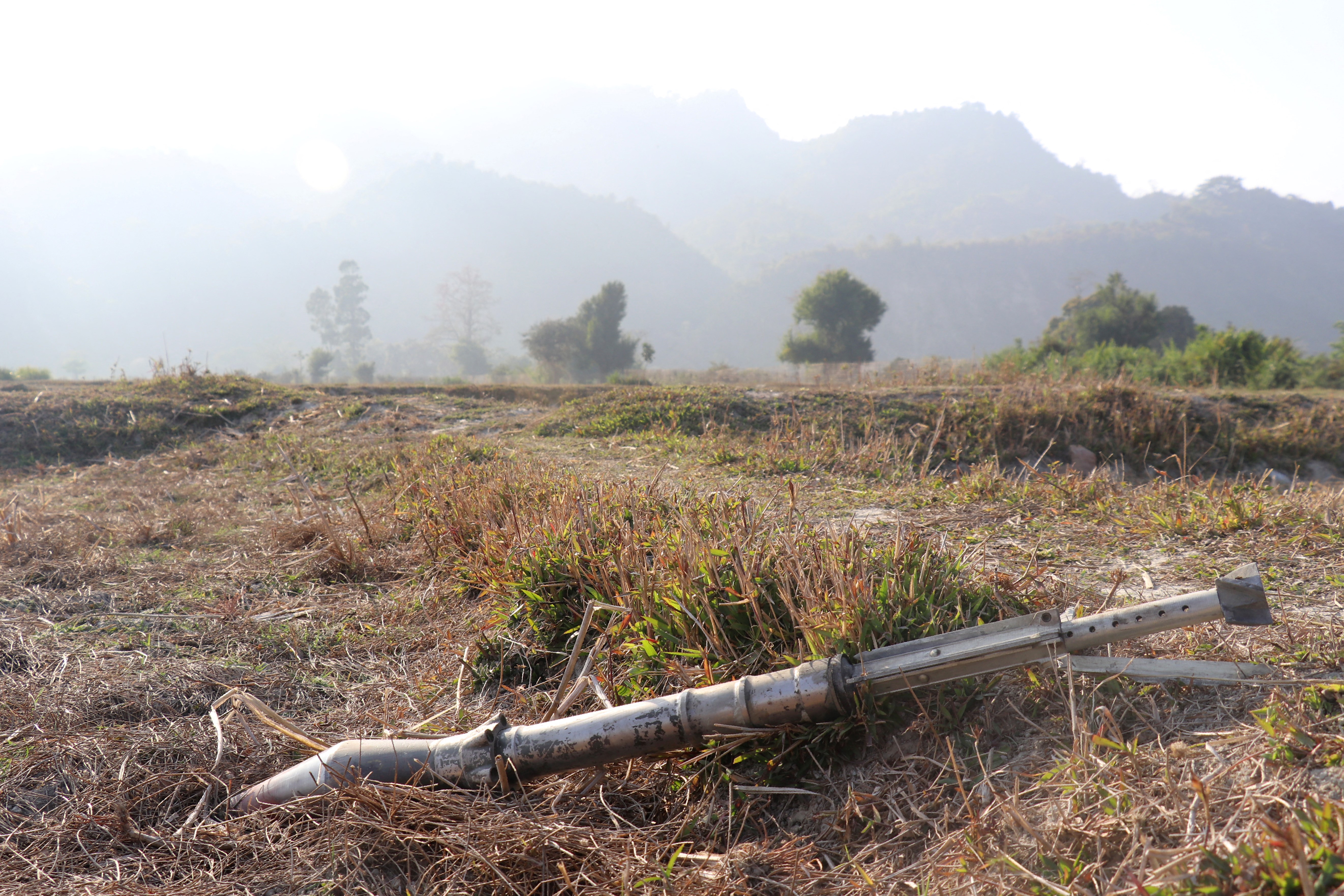 Unexploded ordinance lying in a field of dried brown grass and earth Rathedaung township after fresh fighting in Rakhine state between the Myanmar military and the Arakan Army