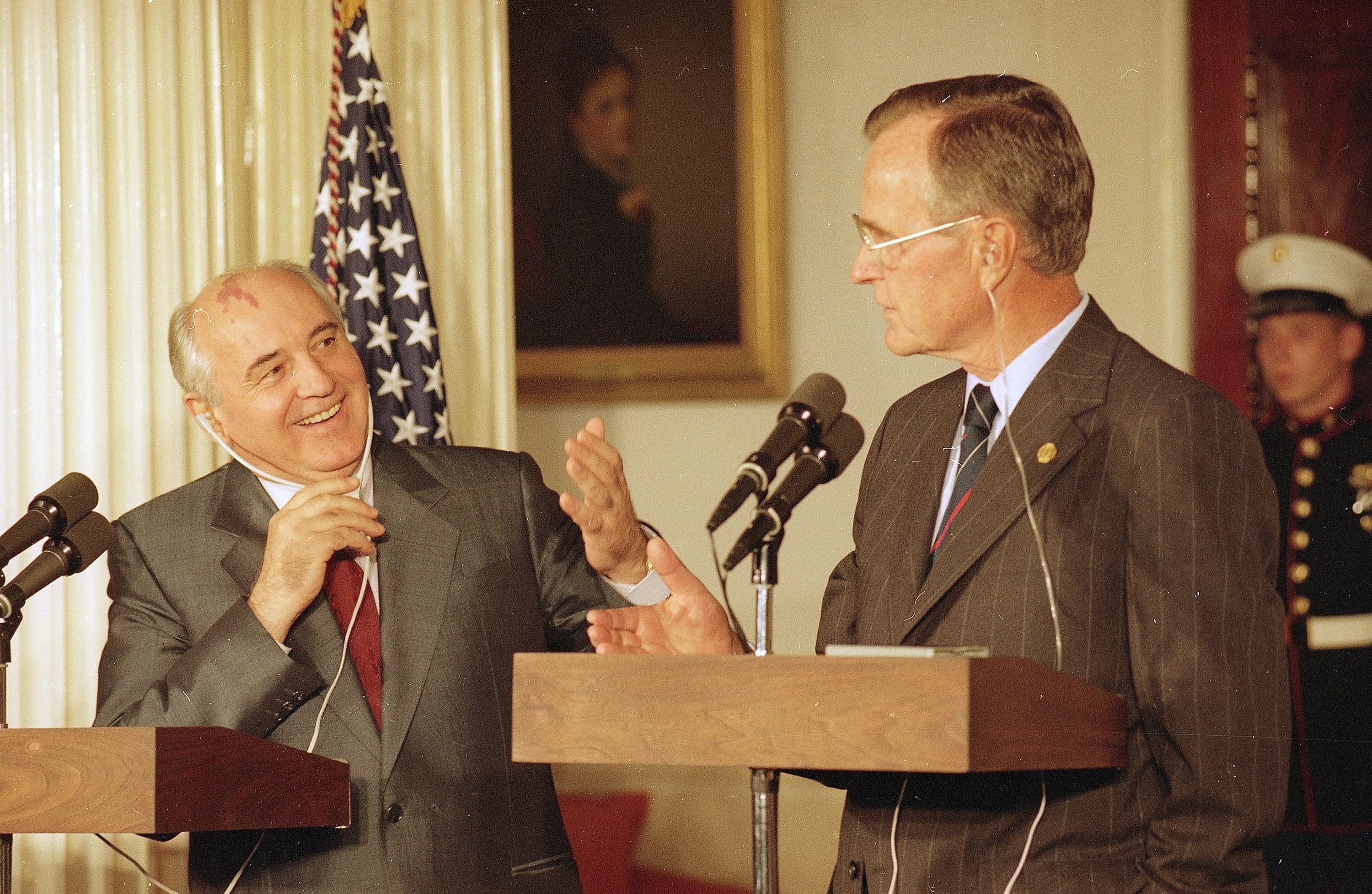 Soviet President Mikhail Gorbachev and US President George Bush talk appear at a news conference in 1991