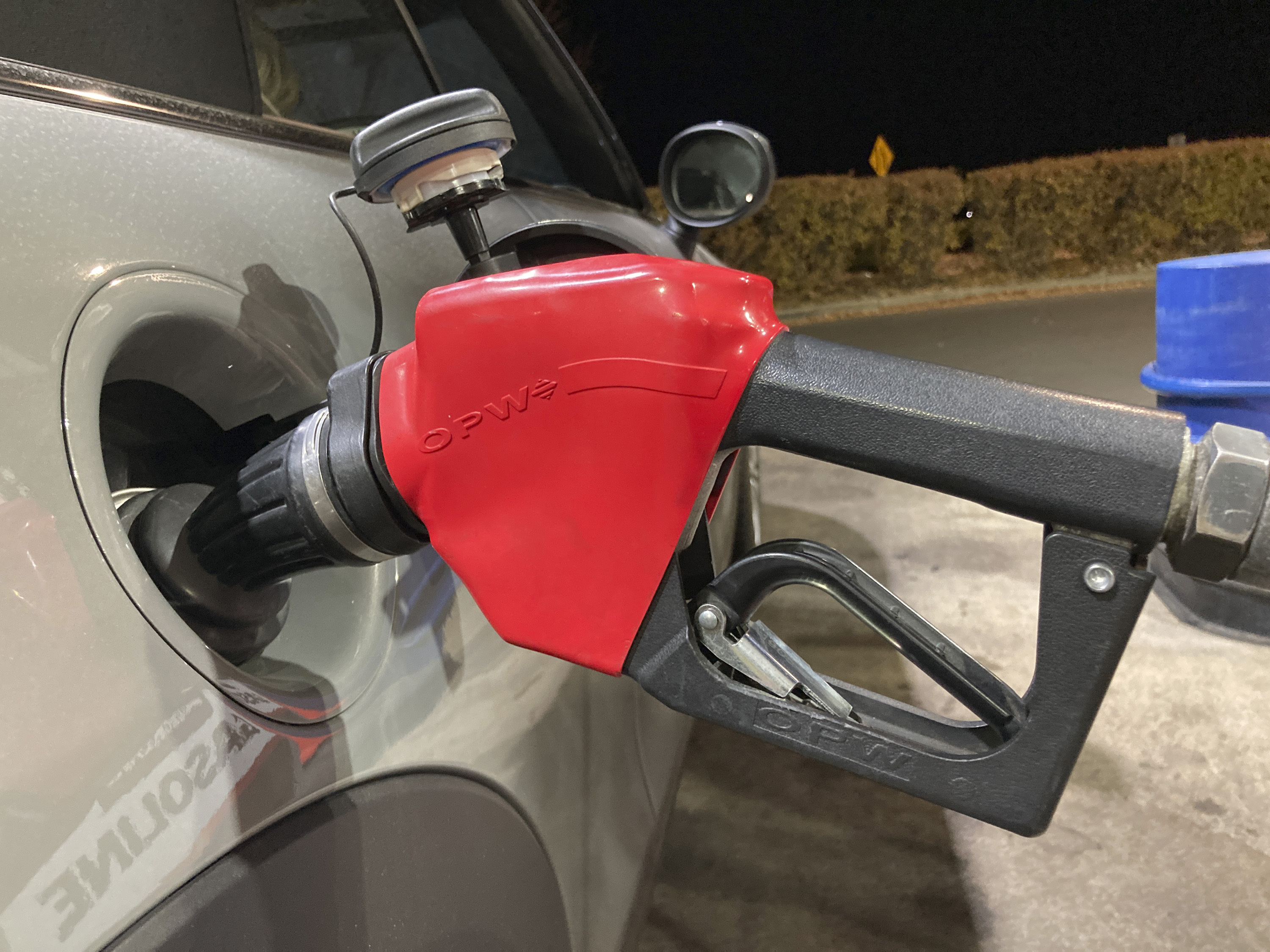 A motorist fills a vehicle with petrol at a pump outside a Costco warehouse in Colorado, US